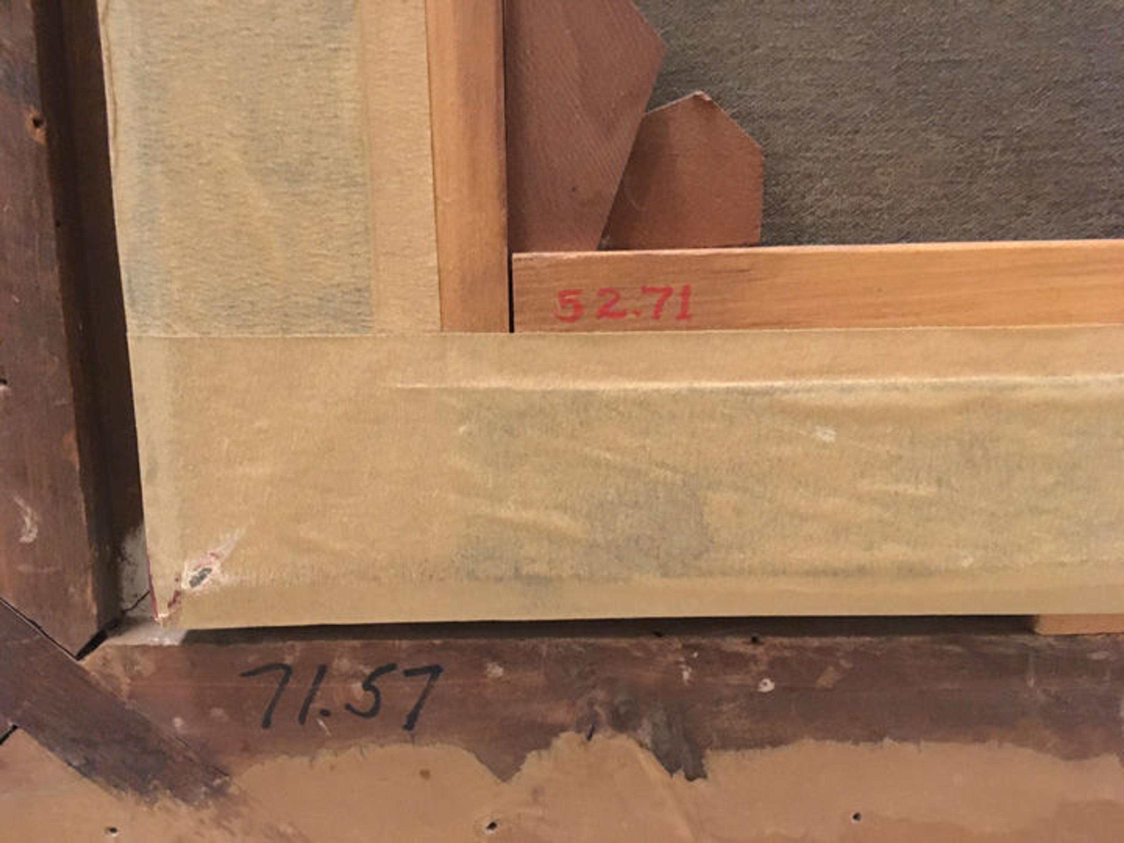 View of the back of a painting frame, showing two different accession numbers