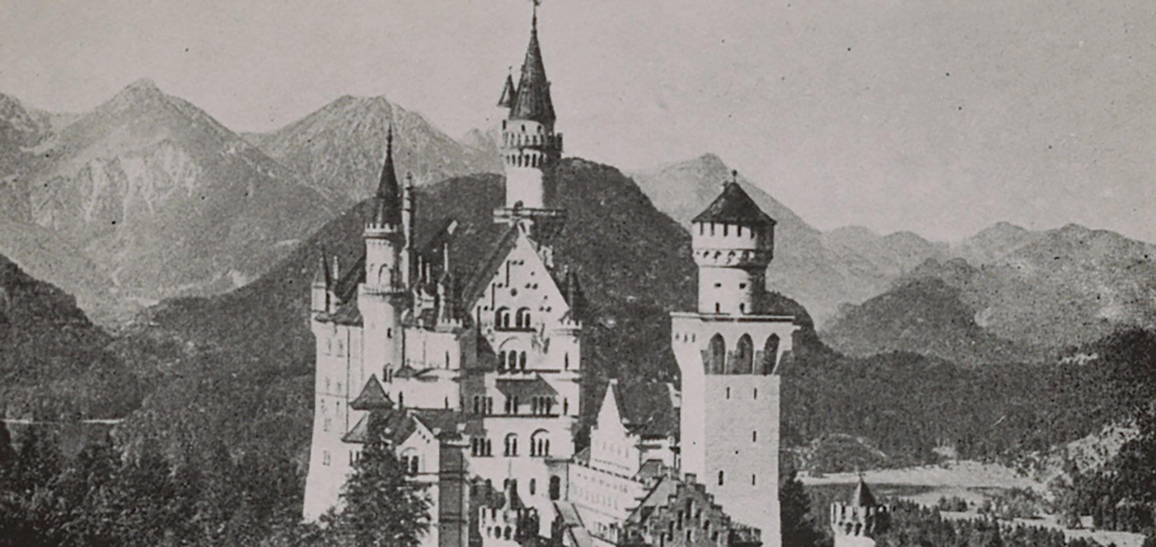 Black-and-white photograph of fairy-tale castle perched on a mountain