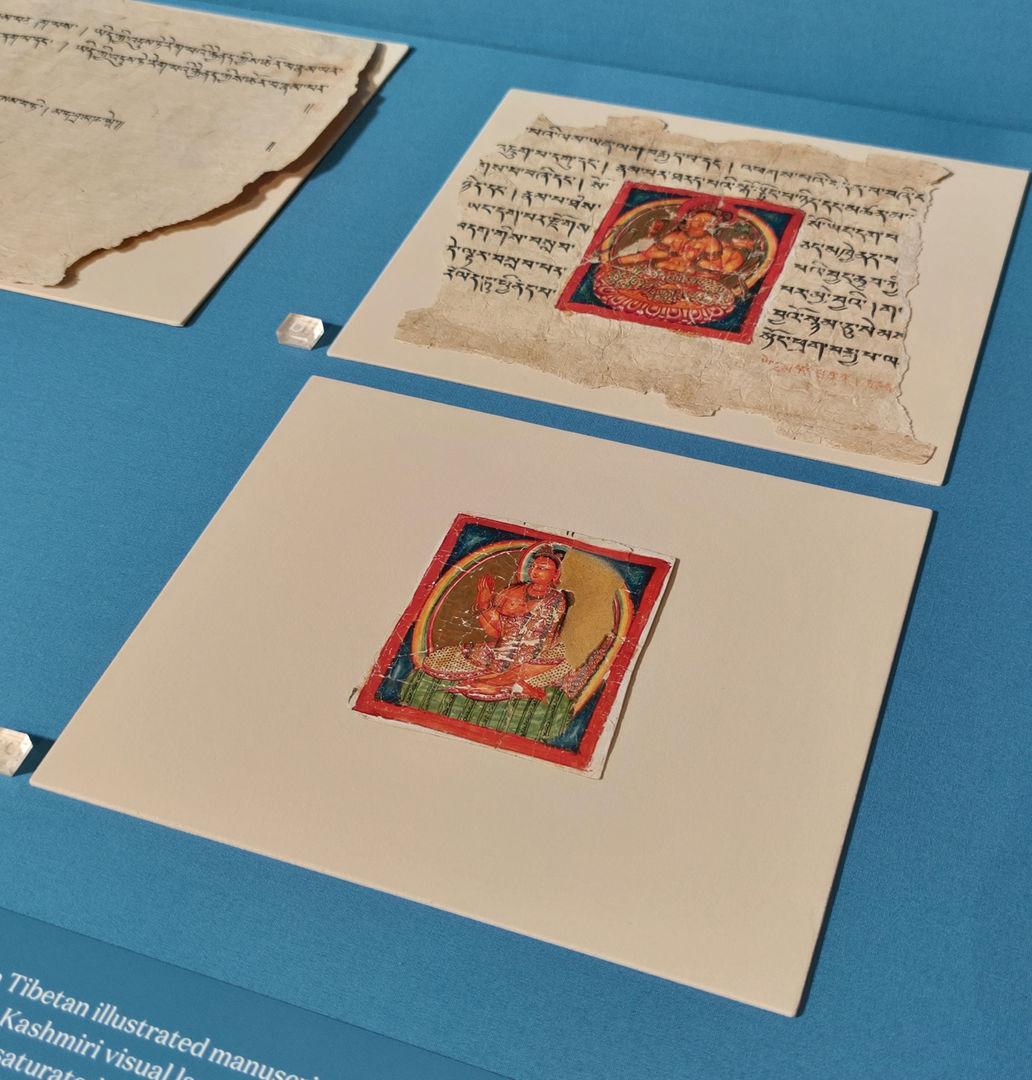 The artwork in its case with the inpainted paper resting on it. Another artwork is placed above