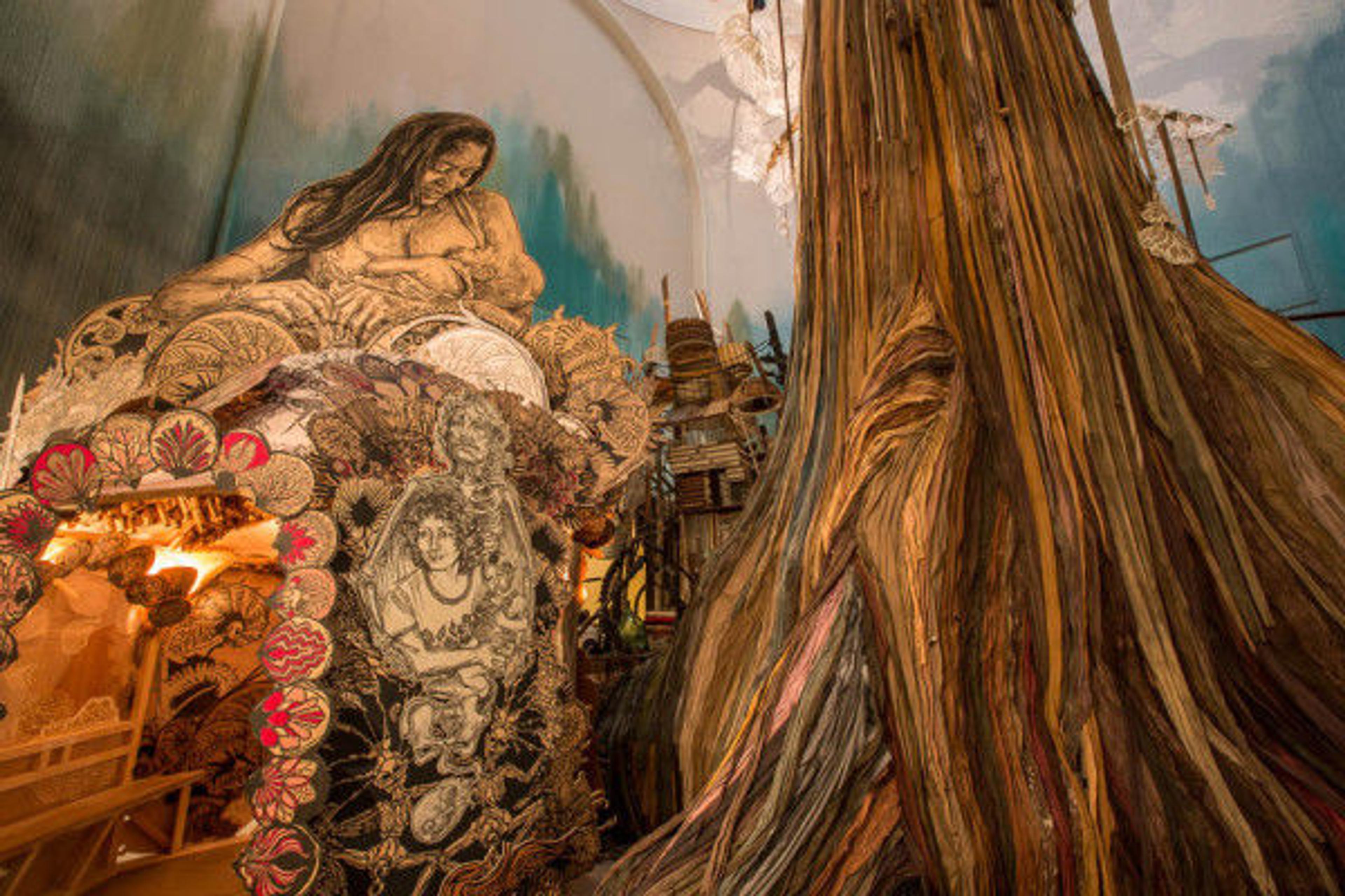 Dawn and Gemma, a painting by Swoon, features as its central image a mother breastfeeding her infant child with a large tree in the foreground