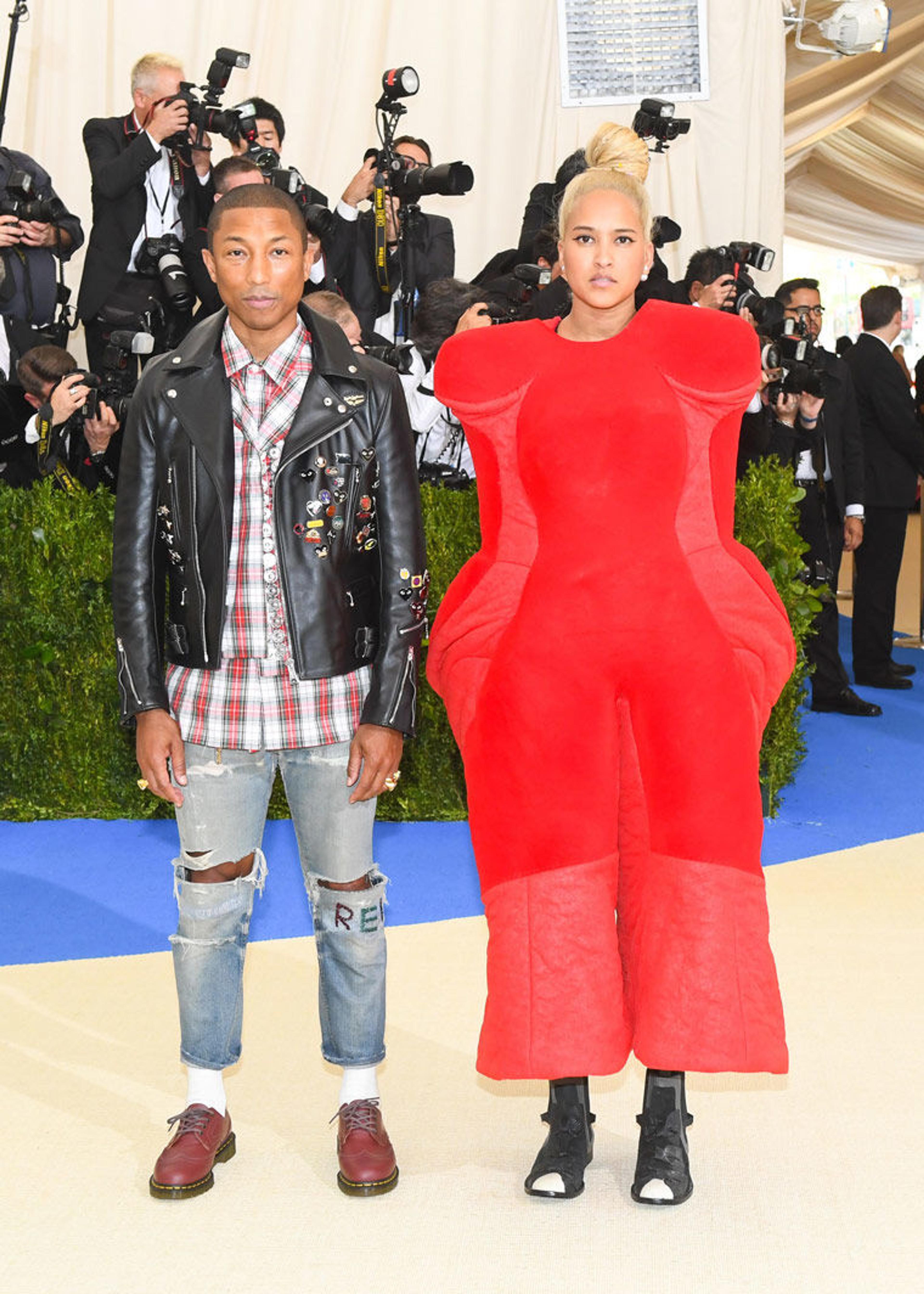 Pharrell Williams and Helen Lasichanh pose on the red carpet in Commes des Garcons at the 2017 Met Gala celebrating Rei Kawakubo