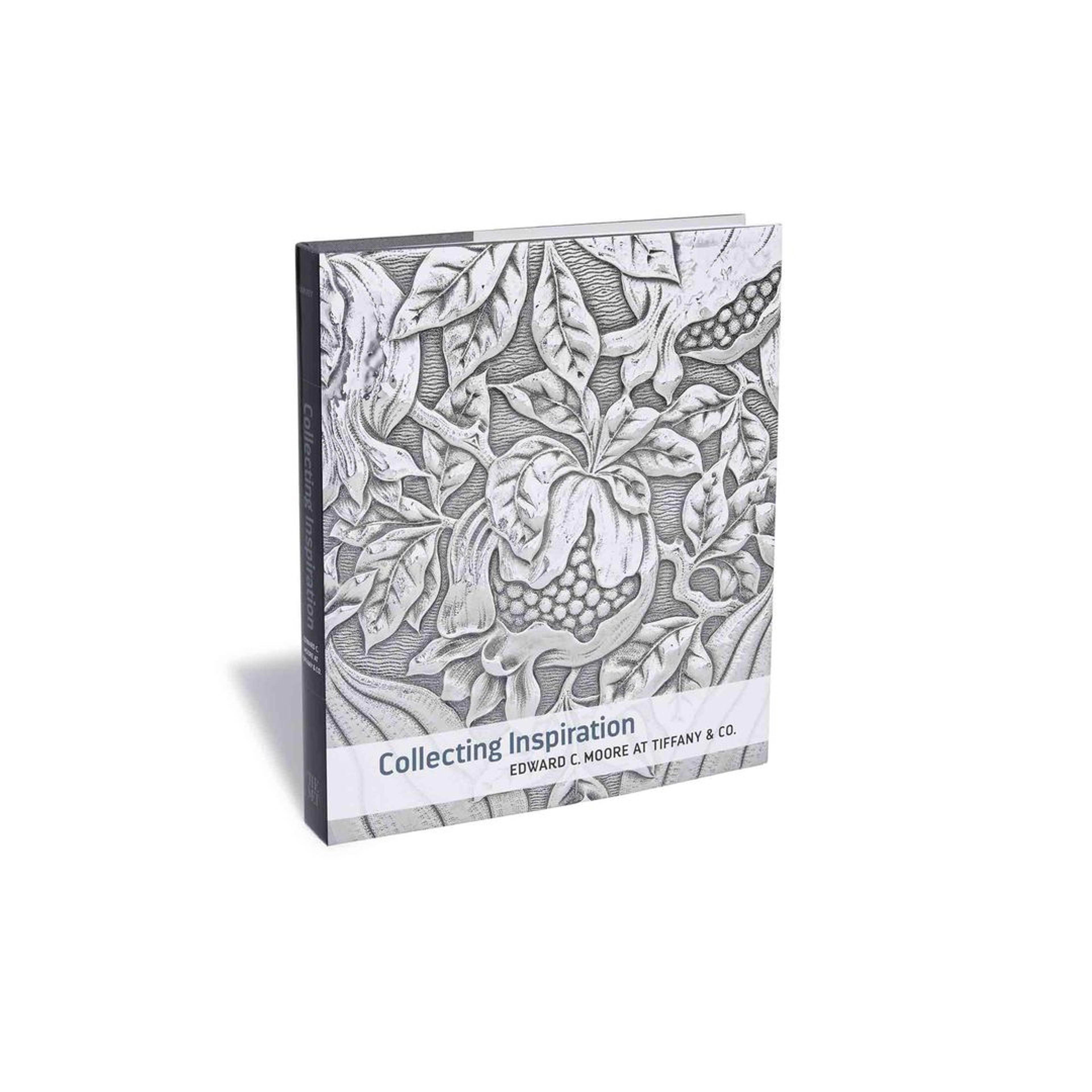 The cover of Collecting Inspiration: Edward C. Moore at Tiffany & Co. A detail of floral embellishments engraved in silver on an object from the Edward C. Moore collection is depicted on the cover.