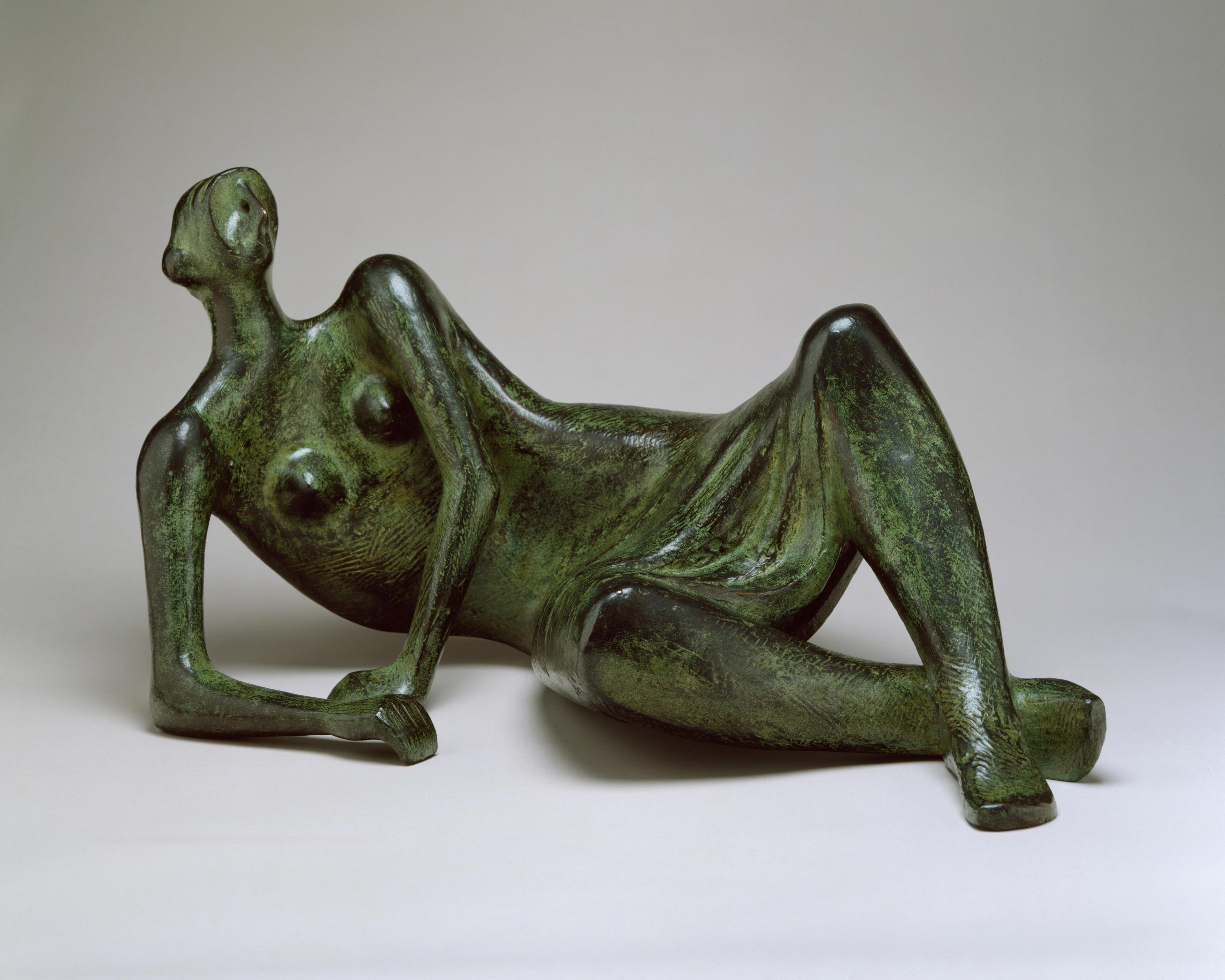 Bronze sculpture of a reclining female figure.