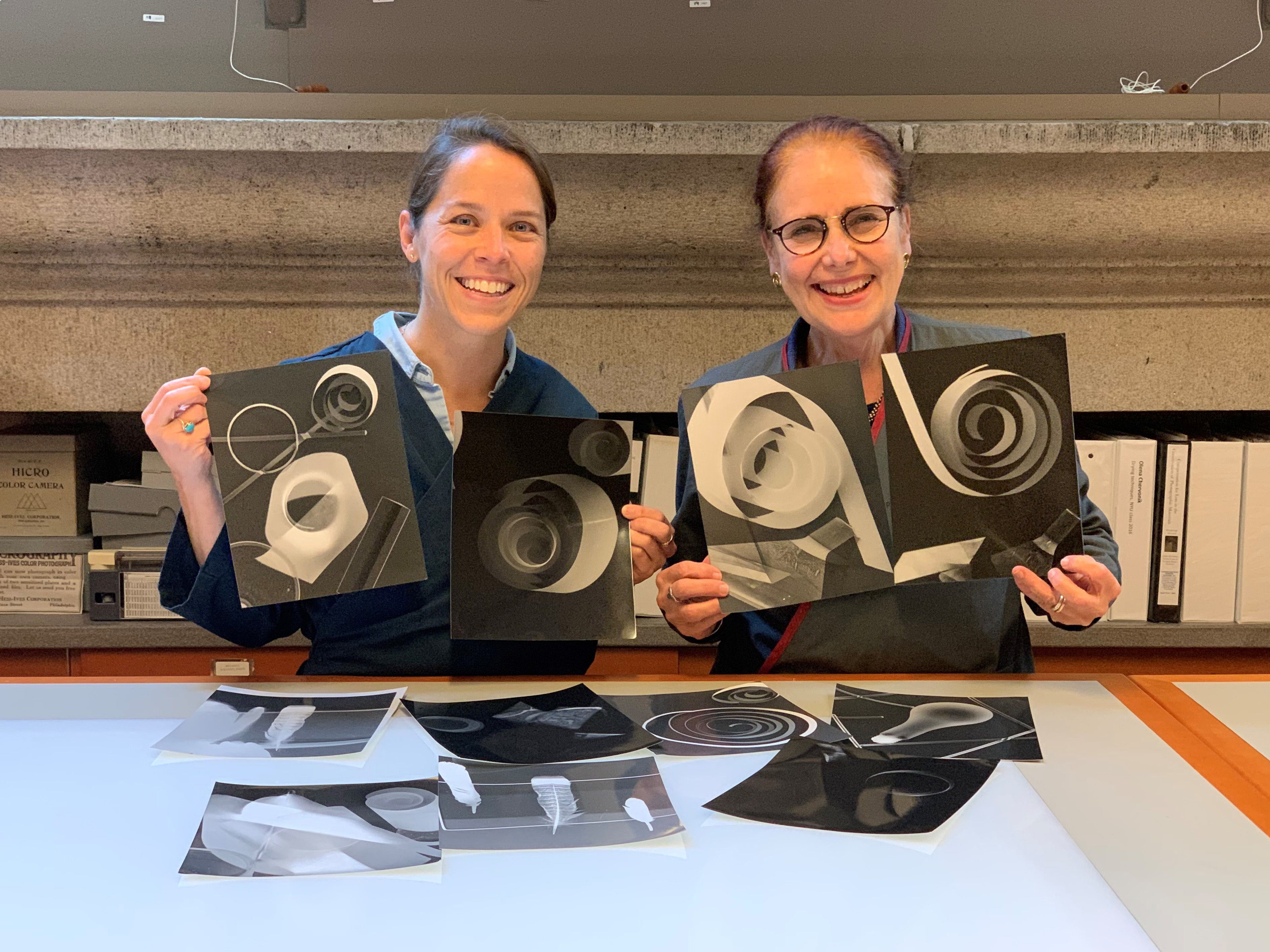 Picture of two conservators showing darkroom experiments