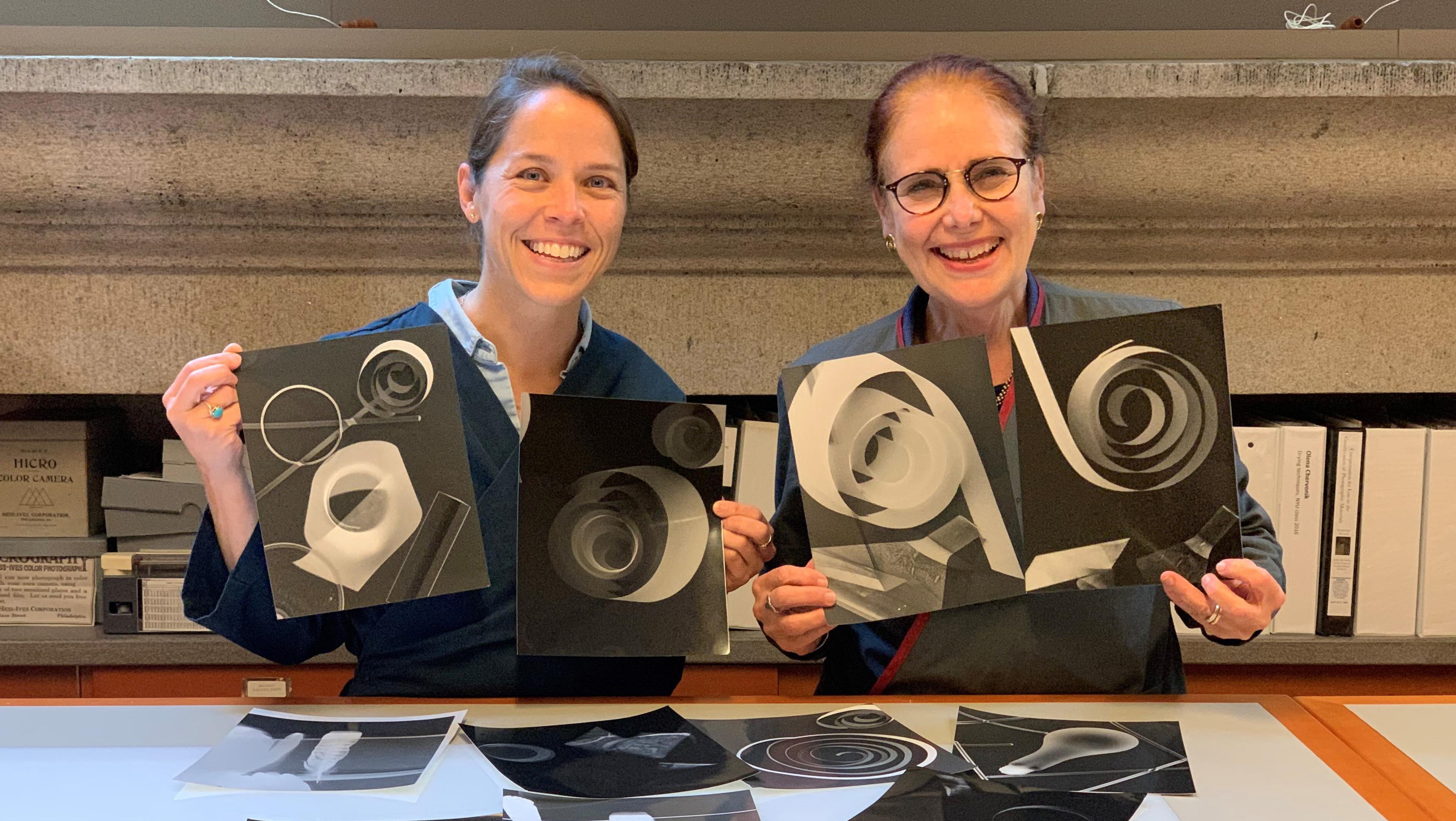Picture of two conservators showing darkroom experiments