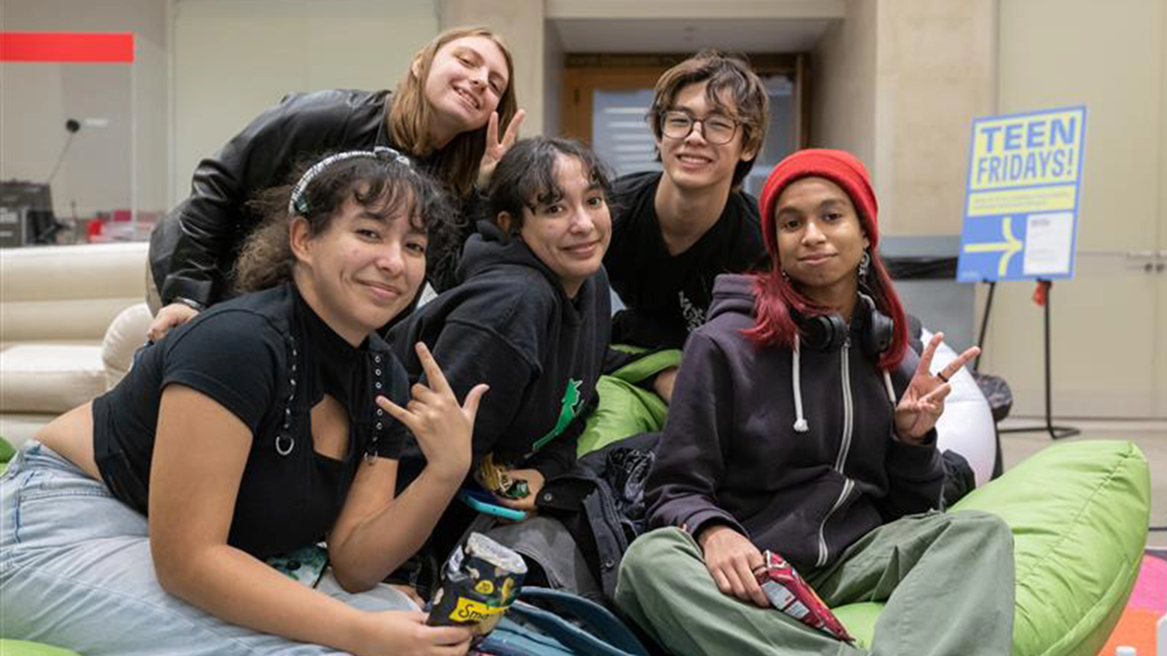 Three teens walking down a hallway in The Met's Ruth and Harold D. Uris Center for Education