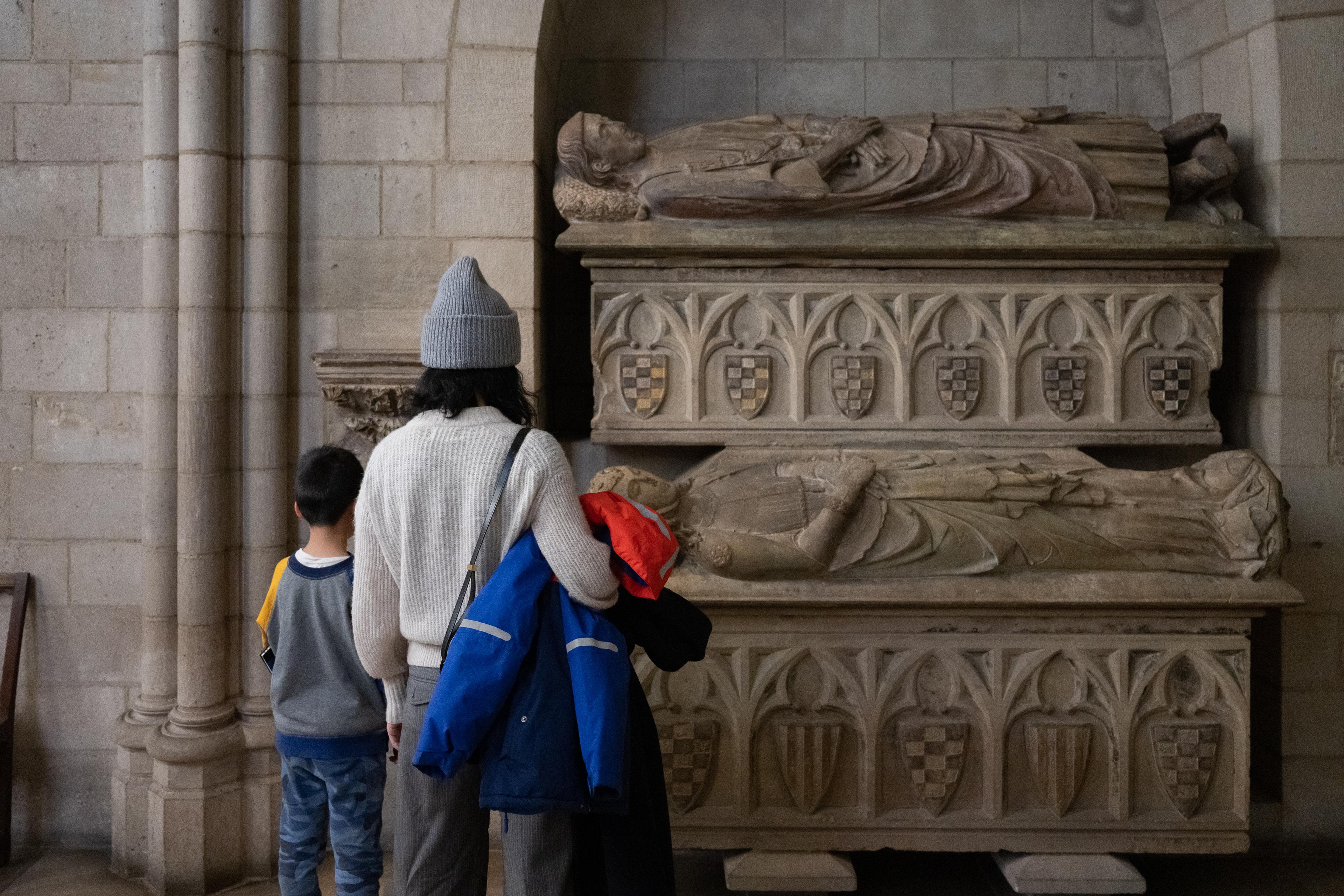 Two individuals look at objects on view at The Met Cloisters.
