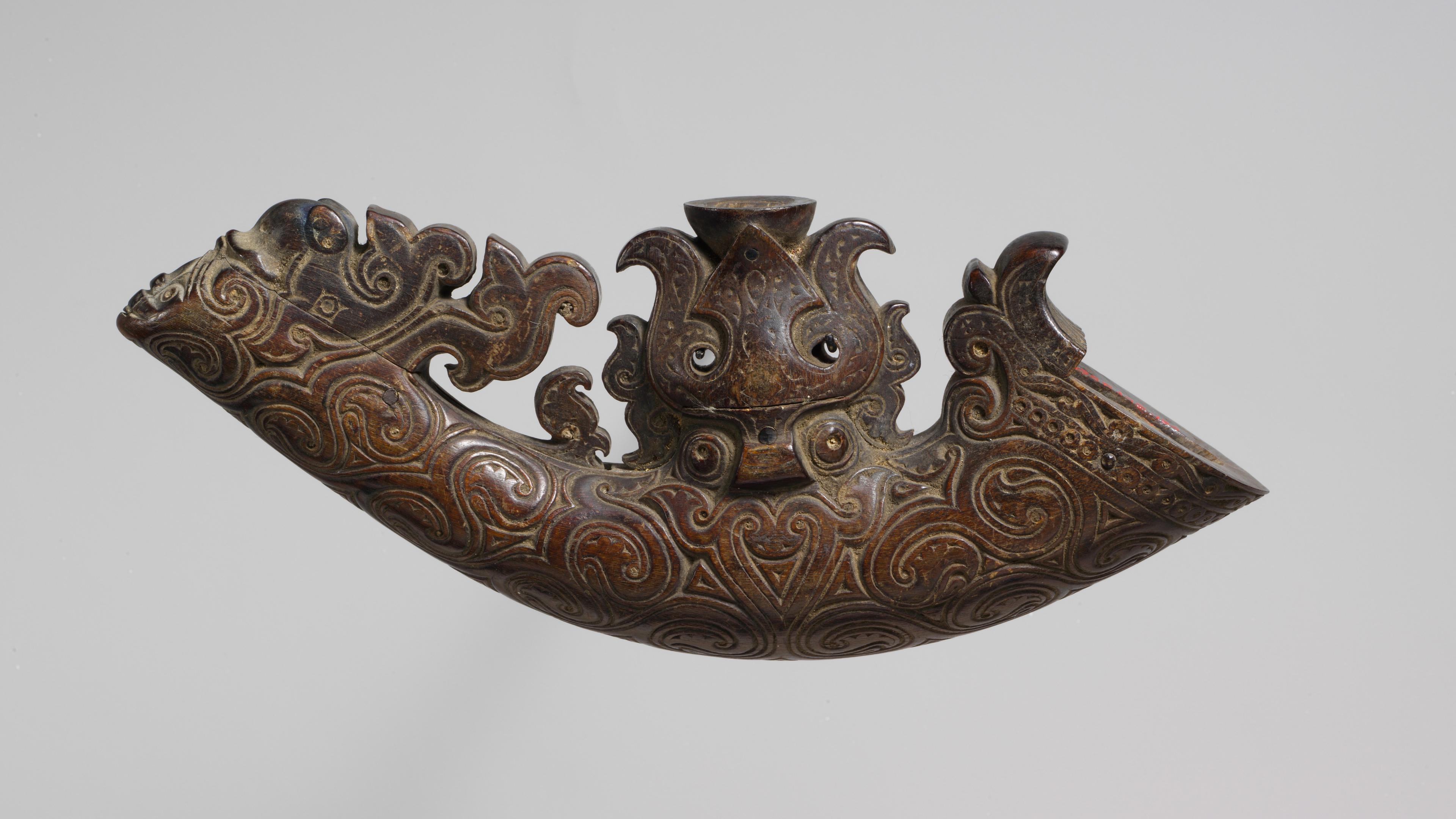 Elaborately carved powder horn for carrying gunpowder.