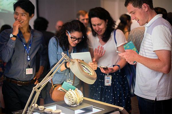 Visitors viewing Kevin's 3D printed Rosary beads in sugar and gypsum, on display at the spring 2015 MediaLab Expo. Photograph by Thomas Ling