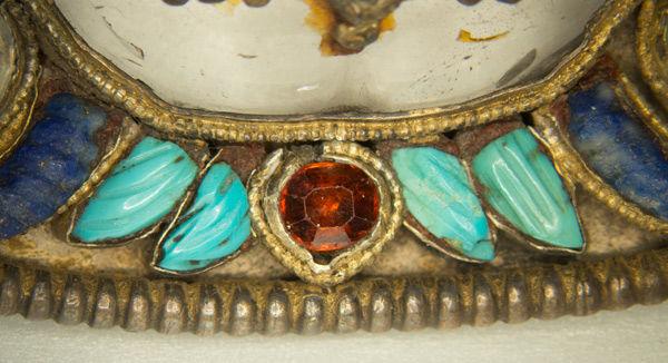 Detail showing bezel setting (center red-orange stone) and opaque red-resin setting (adjacent turquoise and lapis stones). Dish for ritual offerings, 17th–19th century | Nepal | 15.95.168