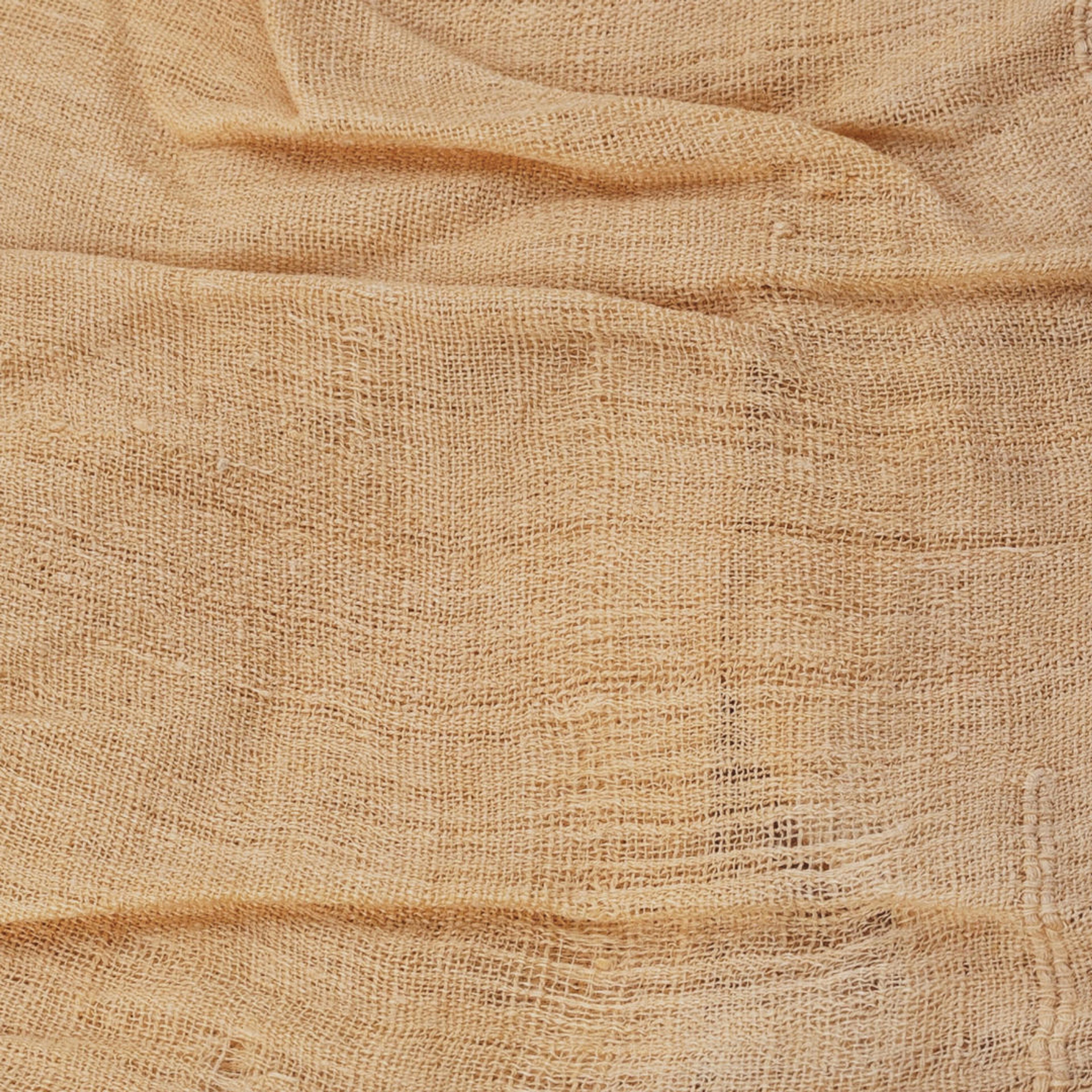 Close-up detail of a sheet of tan linen cloth
