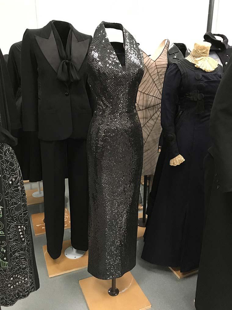 Gray, sequined halter dress on an invisible mount among other ensembles from <em>About Time: Fashion and Duration</em>