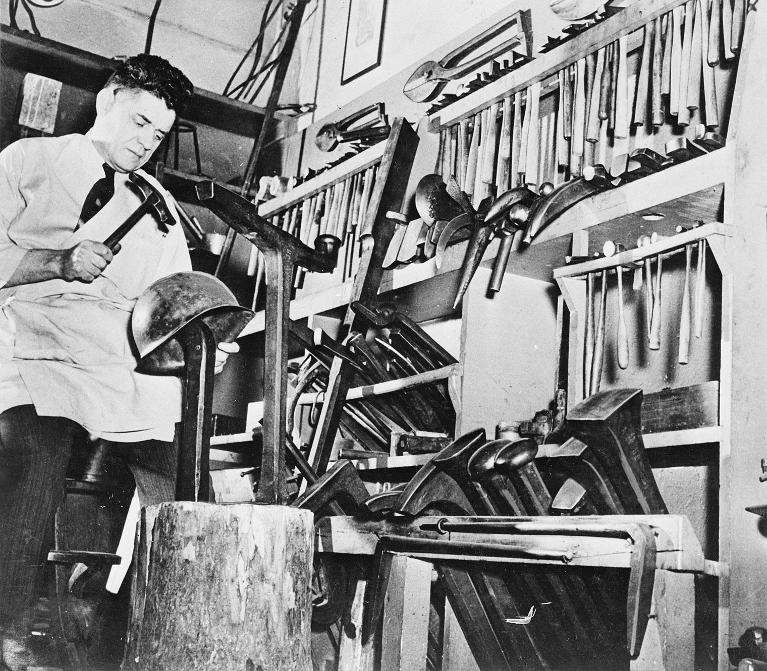 Leonard Heinrich working on a helmet for the United States Army, 1942–45.