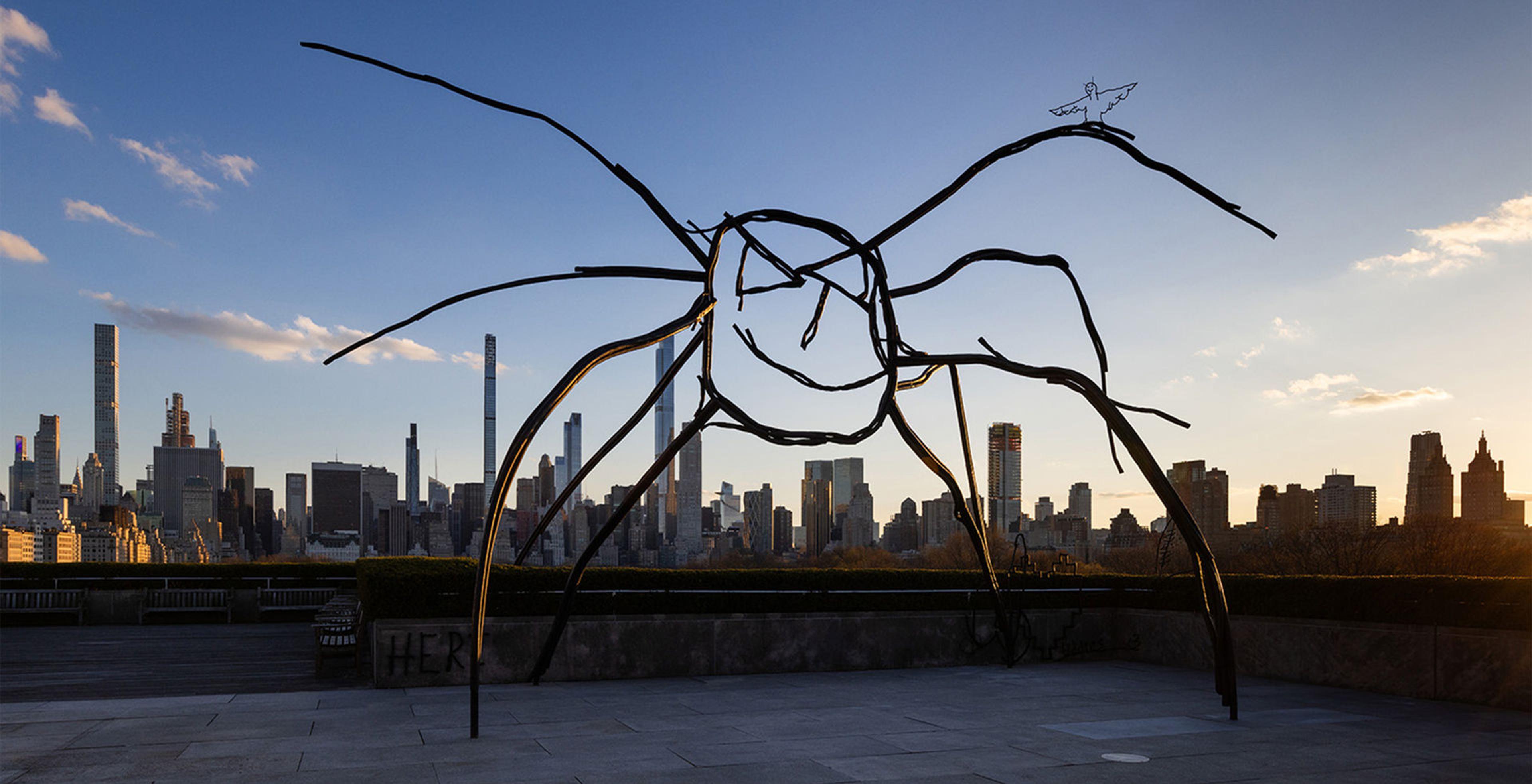 Metal scluped spider with the city skyline in the background. 