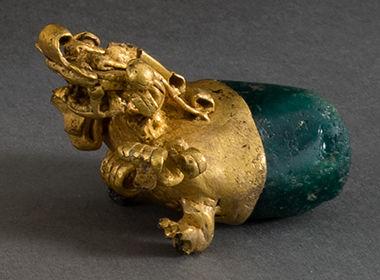 An elaborate gold and emerald pendant from the ancient Americas