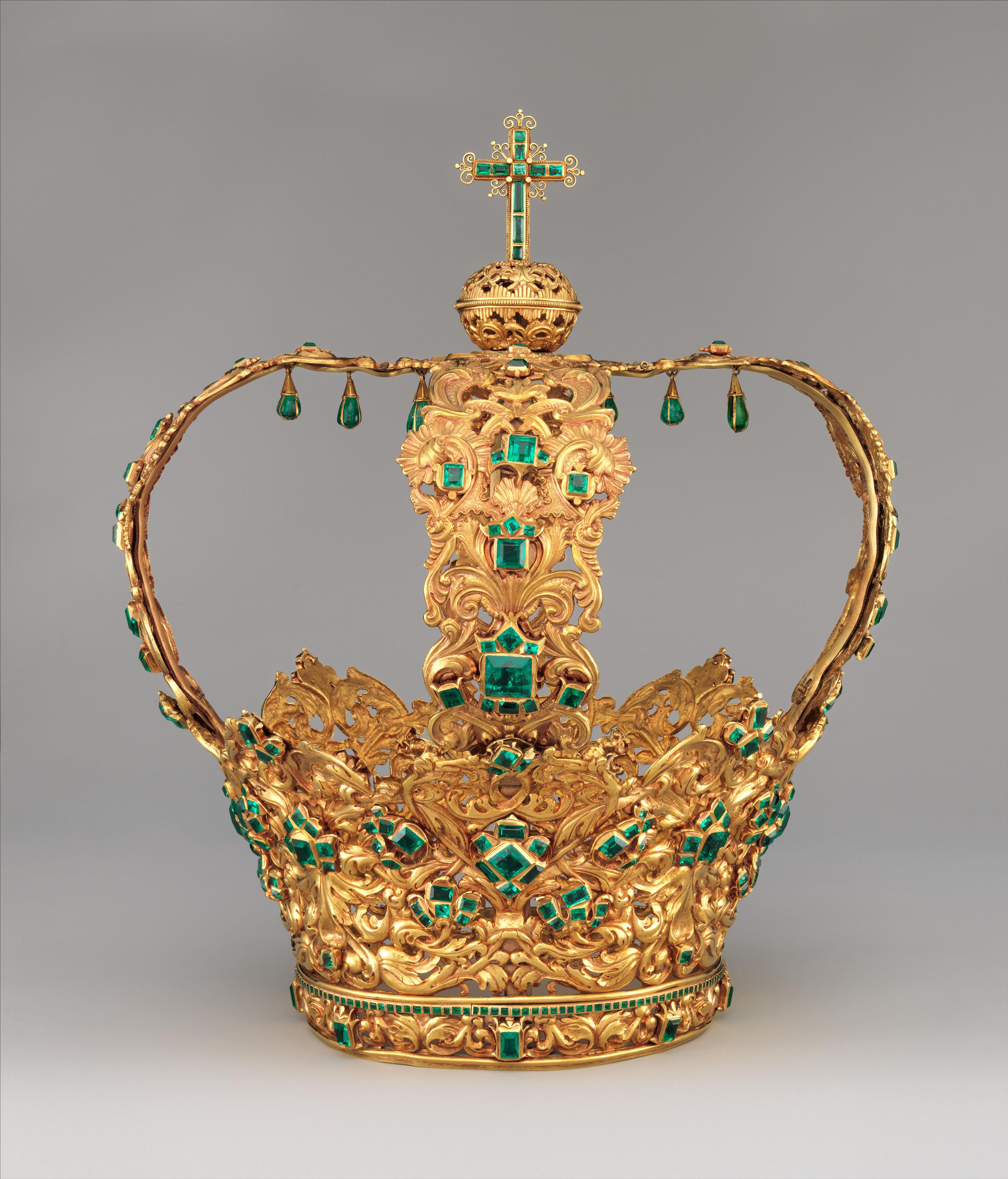 The "Crown of the Andes" made of intricate goldwork and large, teardrop-shaped emeralds suspended in delicate gold settings.