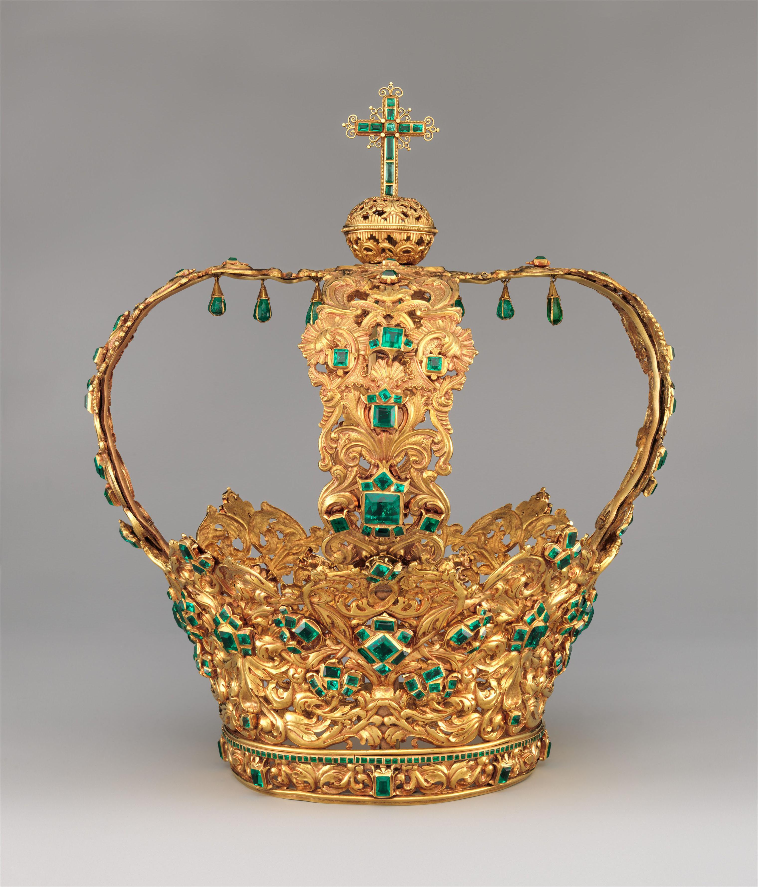 The "Crown of the Andes" made of intricate goldwork and large, teardrop-shaped emeralds suspended in delicate gold settings.