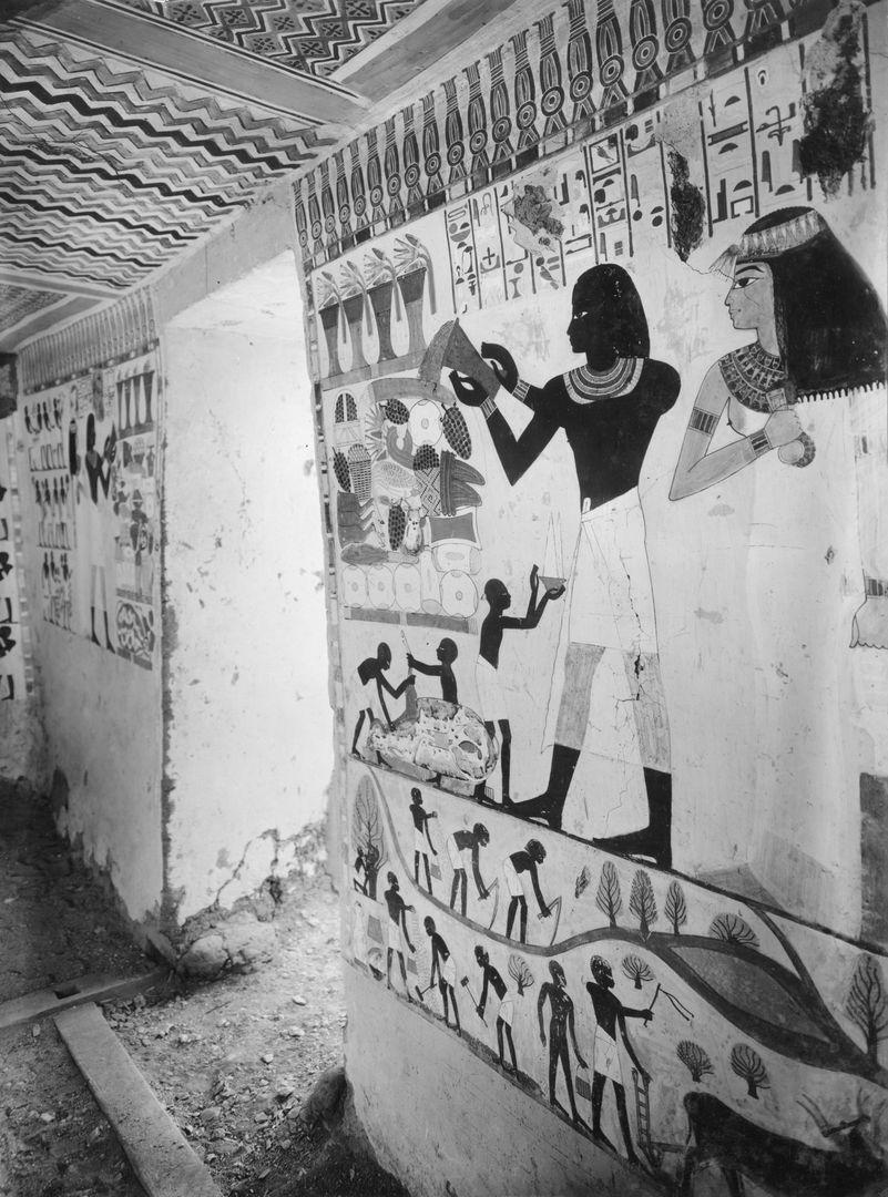Black and white view into a tomb chapel with one wall visible showing a man and his wife