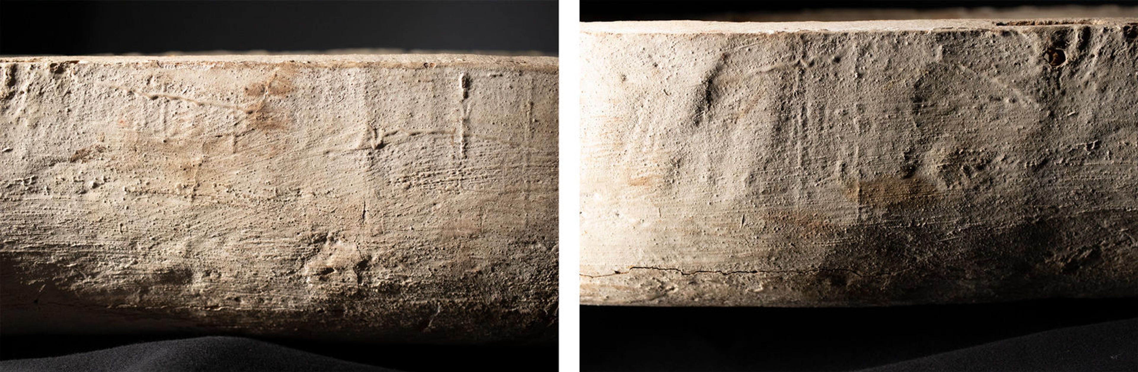 The side of a wooden coffin that has been painted white, photographed with raking light to show the rough texture, the strokes of paintbrushes, and drips of paint.