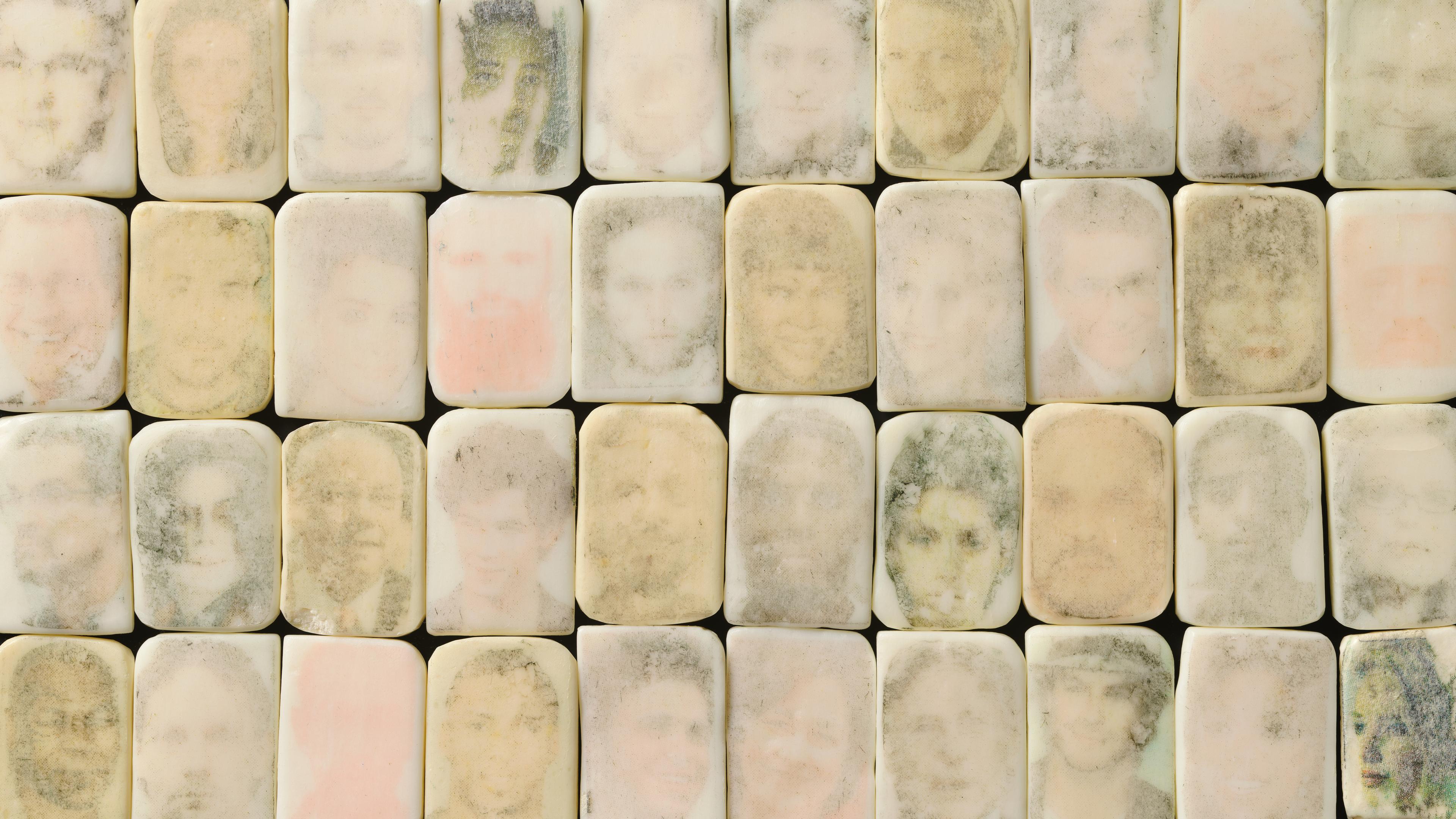 Marble stones aligned with faces drawn on them. 