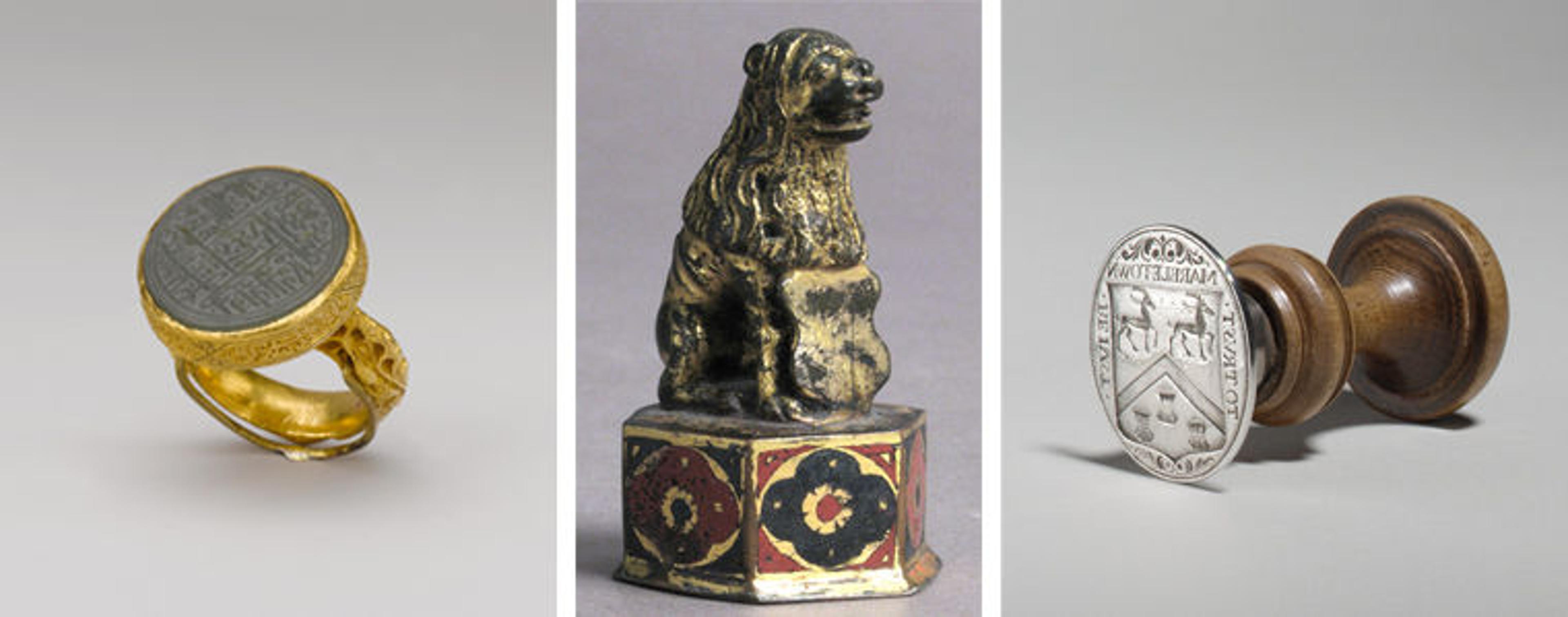 Three seals are shown. The one on the left is on top of a gold ring. The top of the one in the middle is decorated with a small sculpture of an animal, possibly a dog. And the top of the one on the right is made from wood.