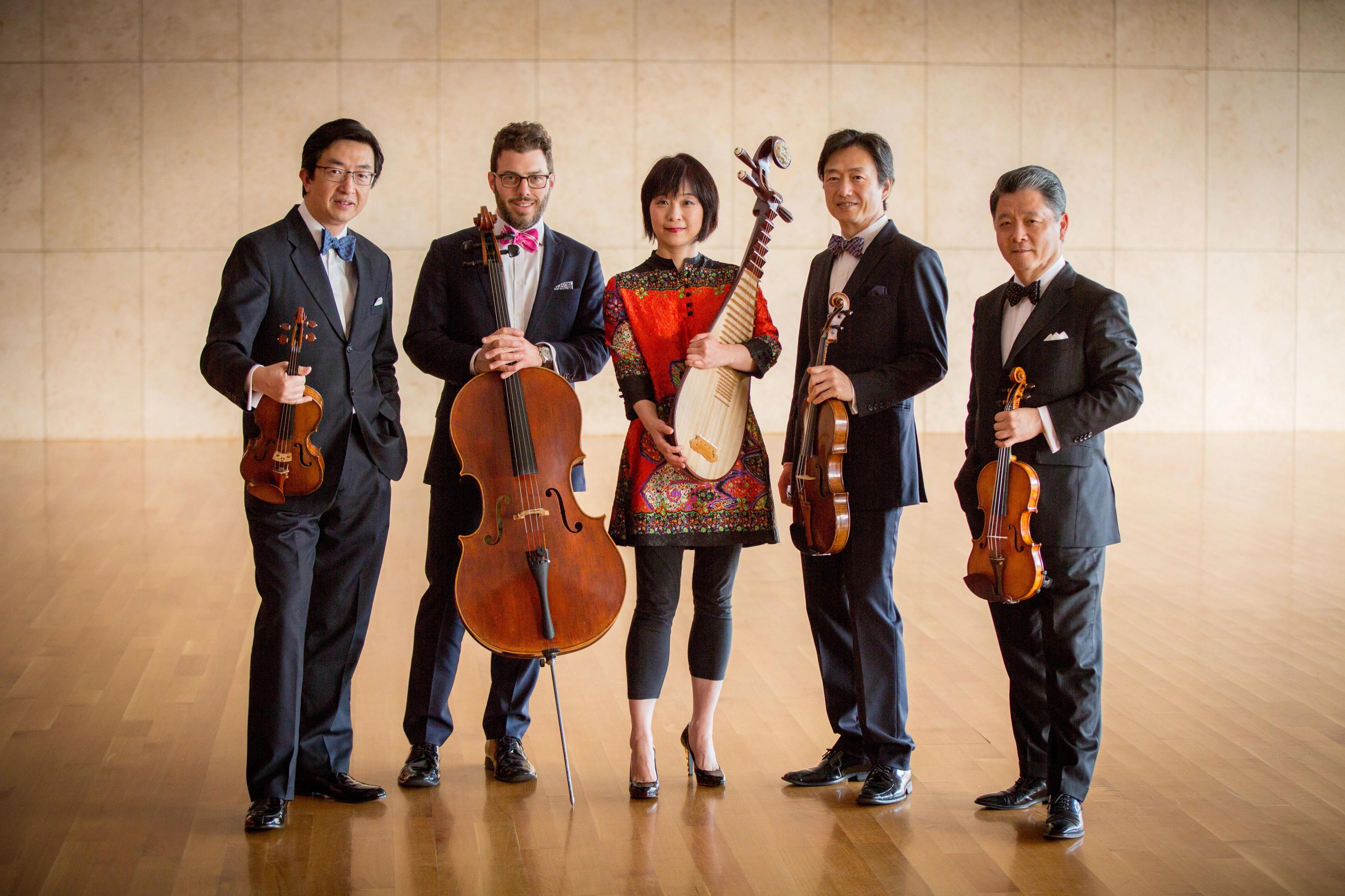 Wu Ma posing at center with four string musicians.