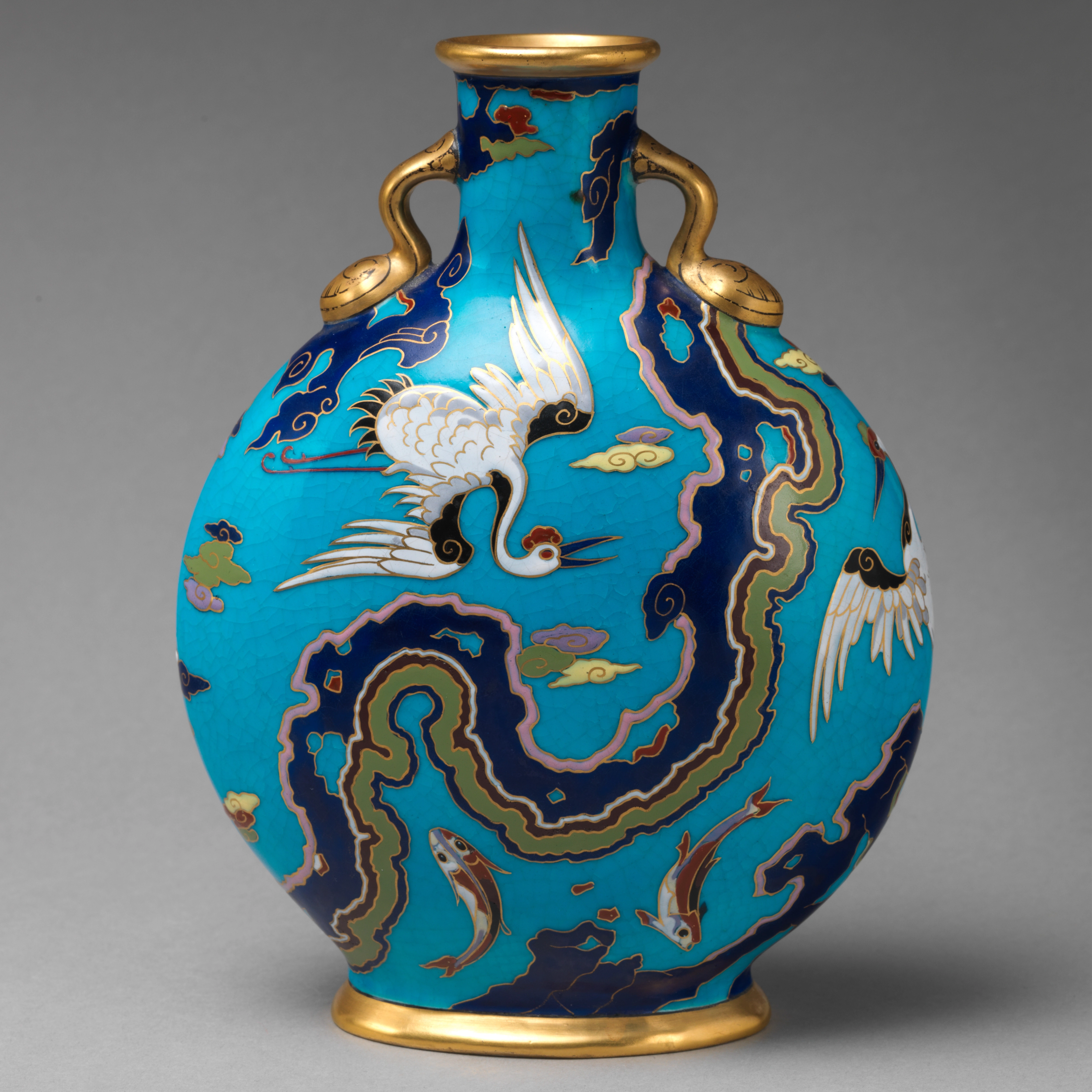 Bone china moon flask with crane and fish motifs against a blue background.