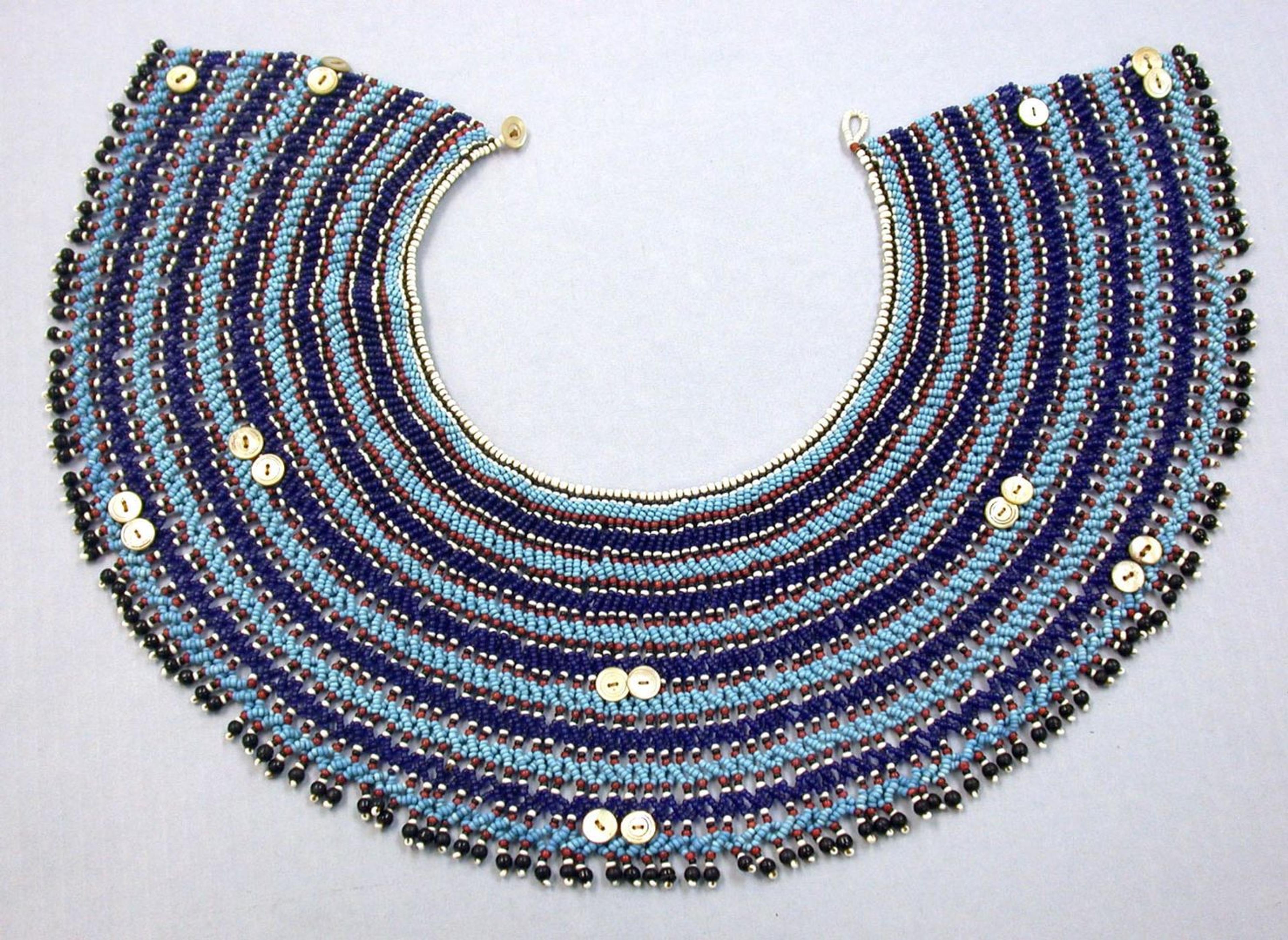 A South African collar made by the Xhosa or Mfengu or Nguni peoples made of beads, fiber, buttons, and leather