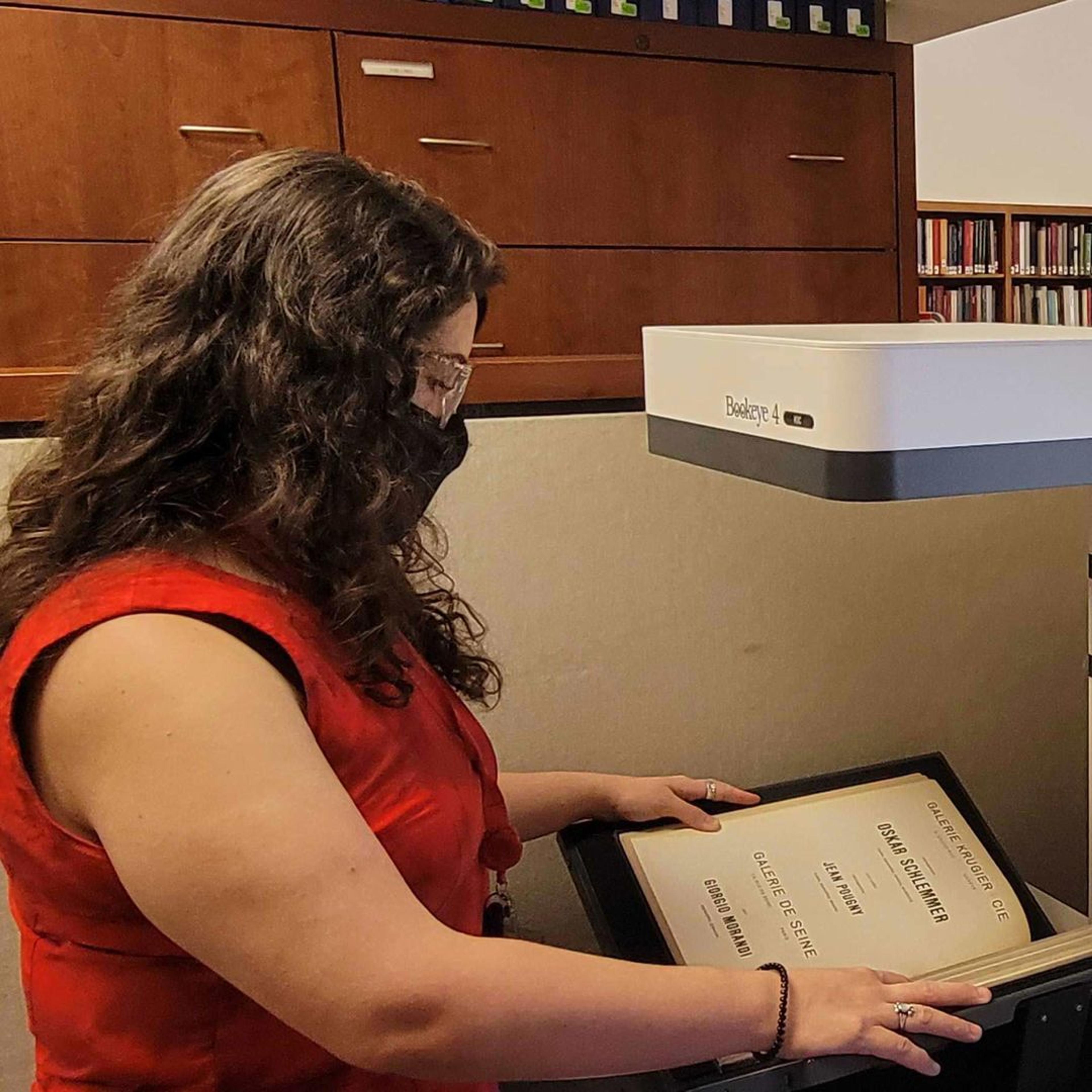 Librarian scanning a book