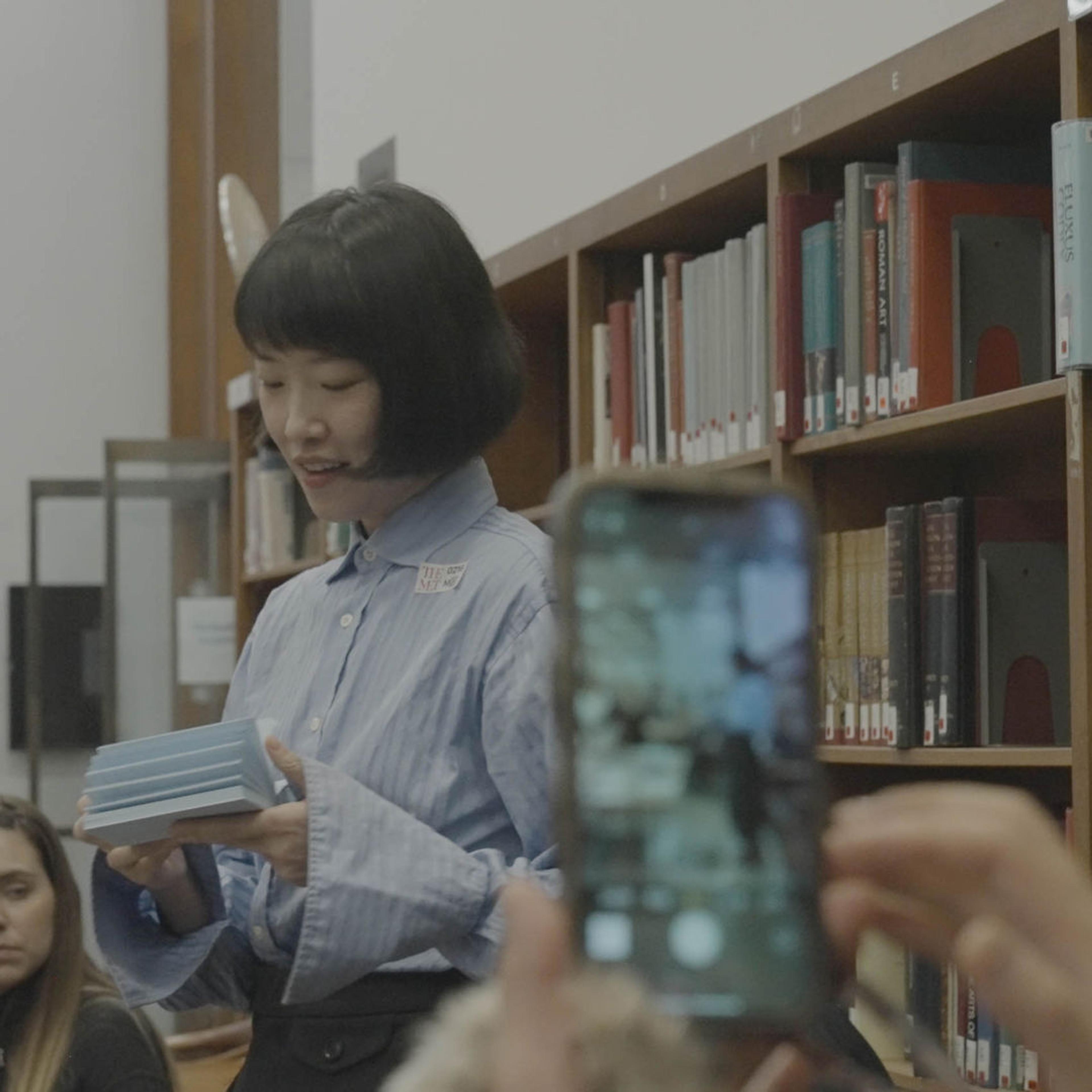 Person filming speaker on their cellphone