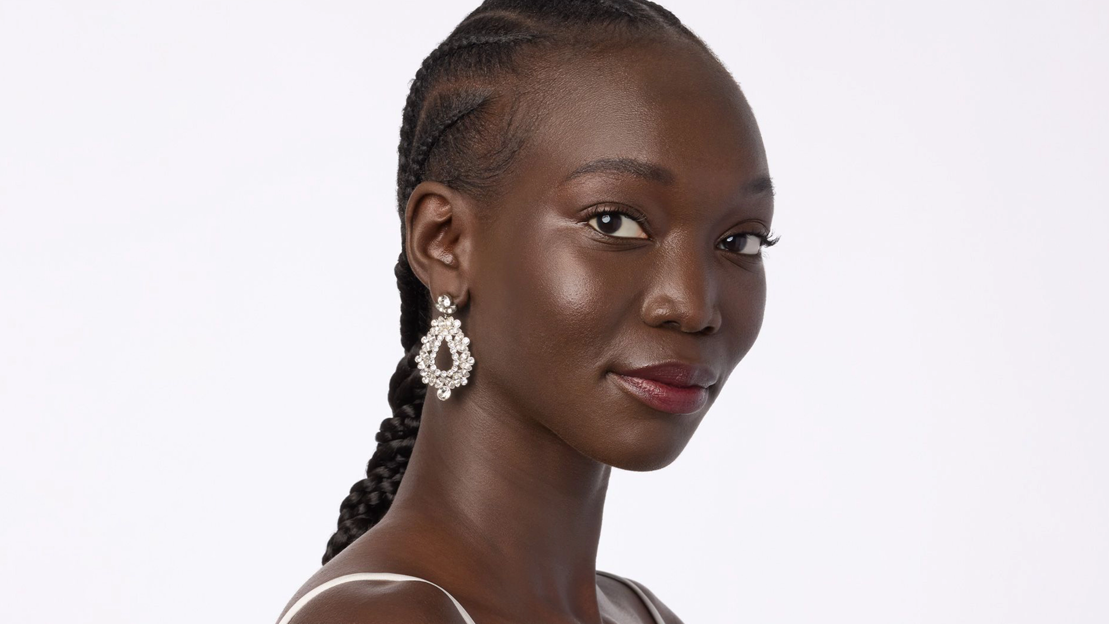 A woman wearing sparkly earrings.