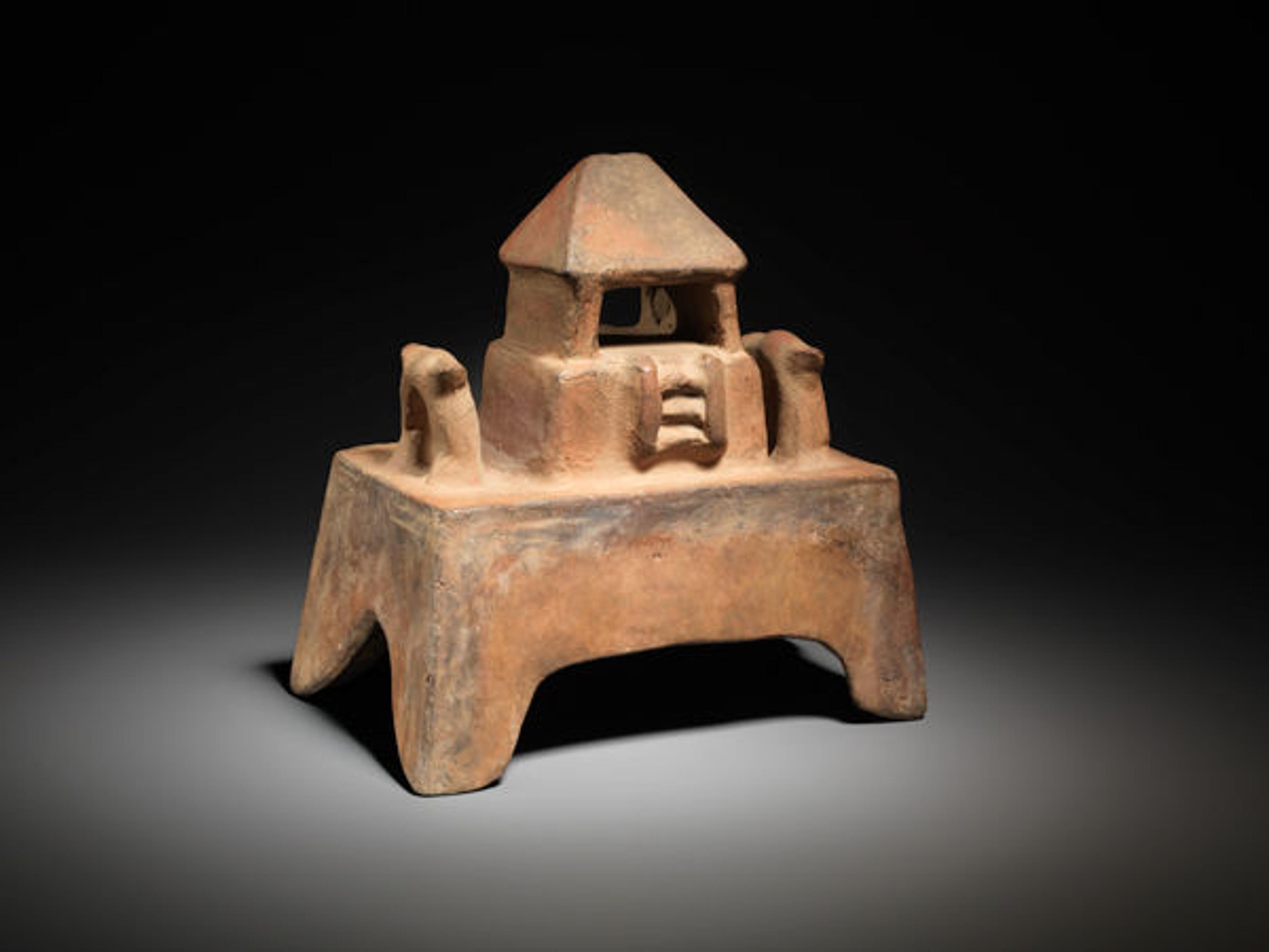 This small platform surmounted by a temple with a peaked roof may have once served as the lid for an incense burner. Temple model, 200 B.C.–A.D. 300. Colima, Mexico. Ceramic; H. 7 1/8 in. The Metropolitan Museum of Art, New York, From the Collection of Nina and Gordon Bunshaft, Bequest of Nina Bunshaft, 1994 (1995.63.5)