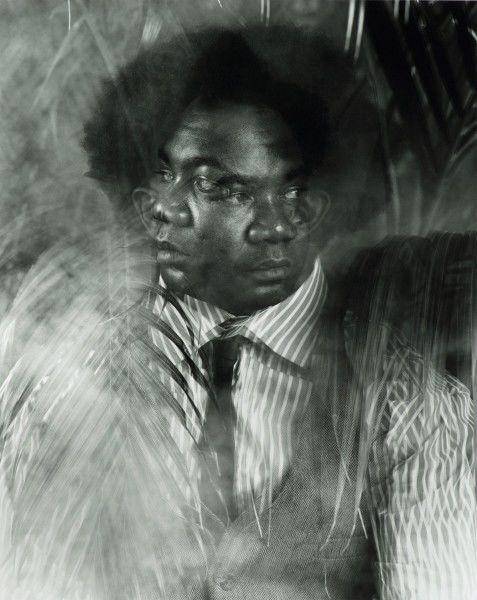 A black and white portrait by Rashid Johnson made with multiple exposures showing a man with multiple faces