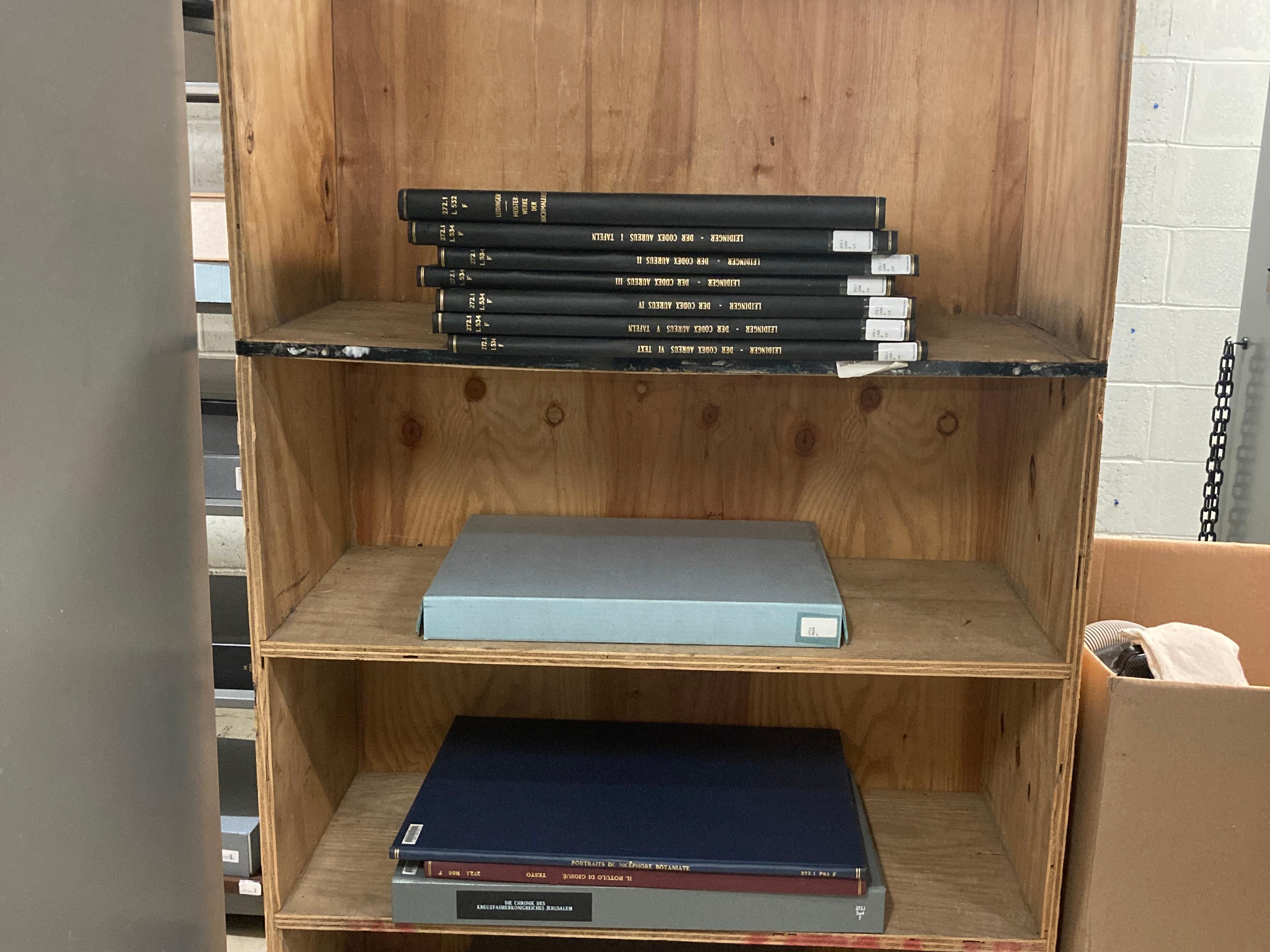 Folios sitting in a large, wooden carrying case