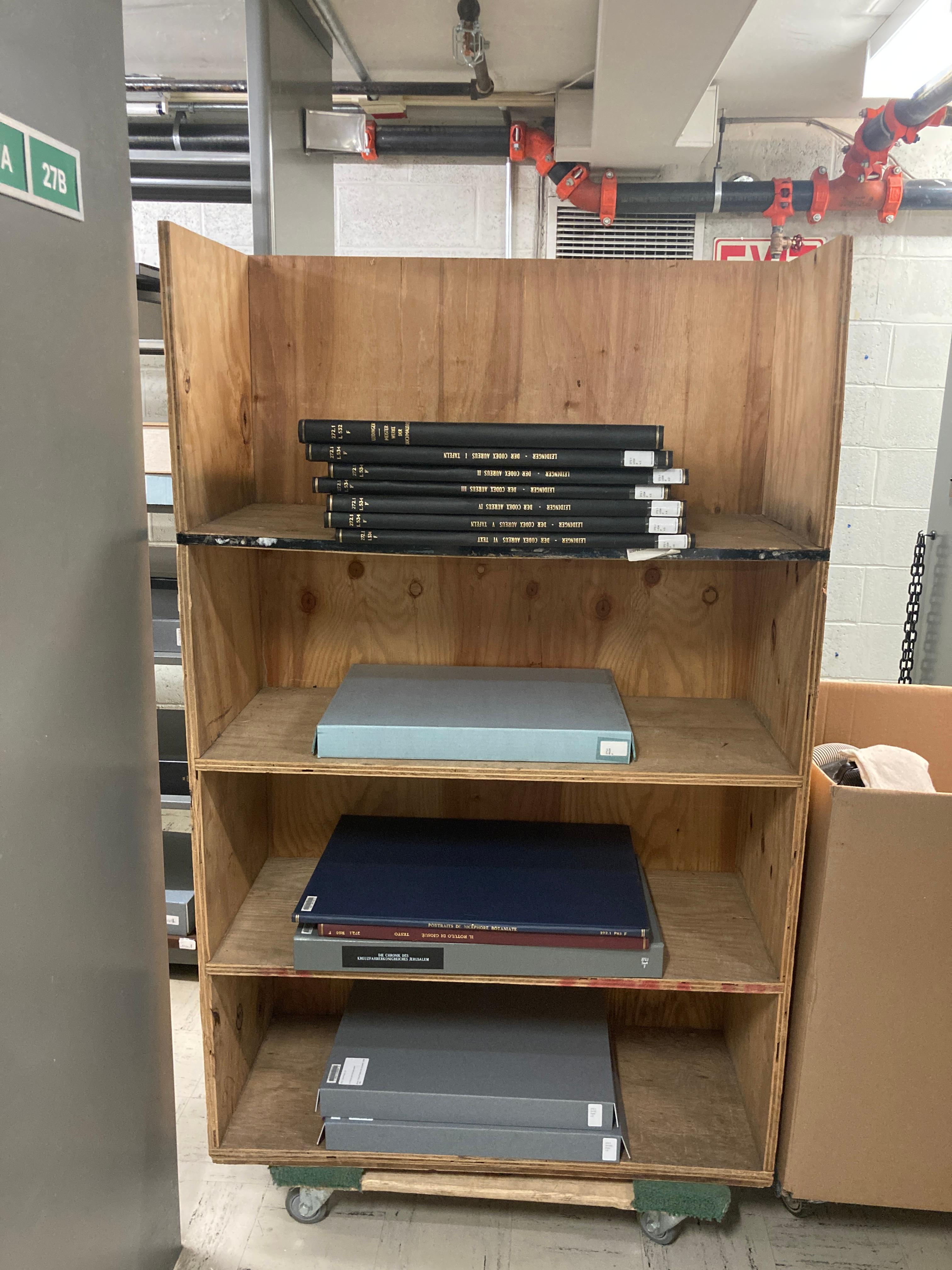 Folios sitting in a large, wooden carrying case