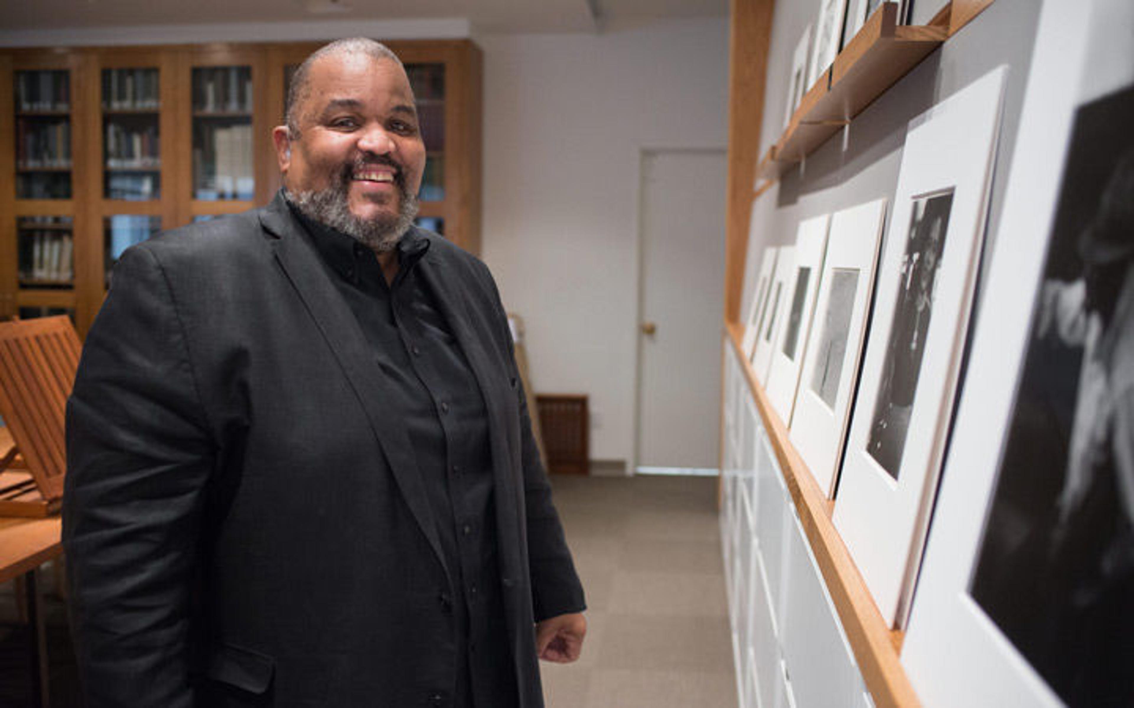 Photographer and educator Dawoud Bey stands before a series of photographs at The Met