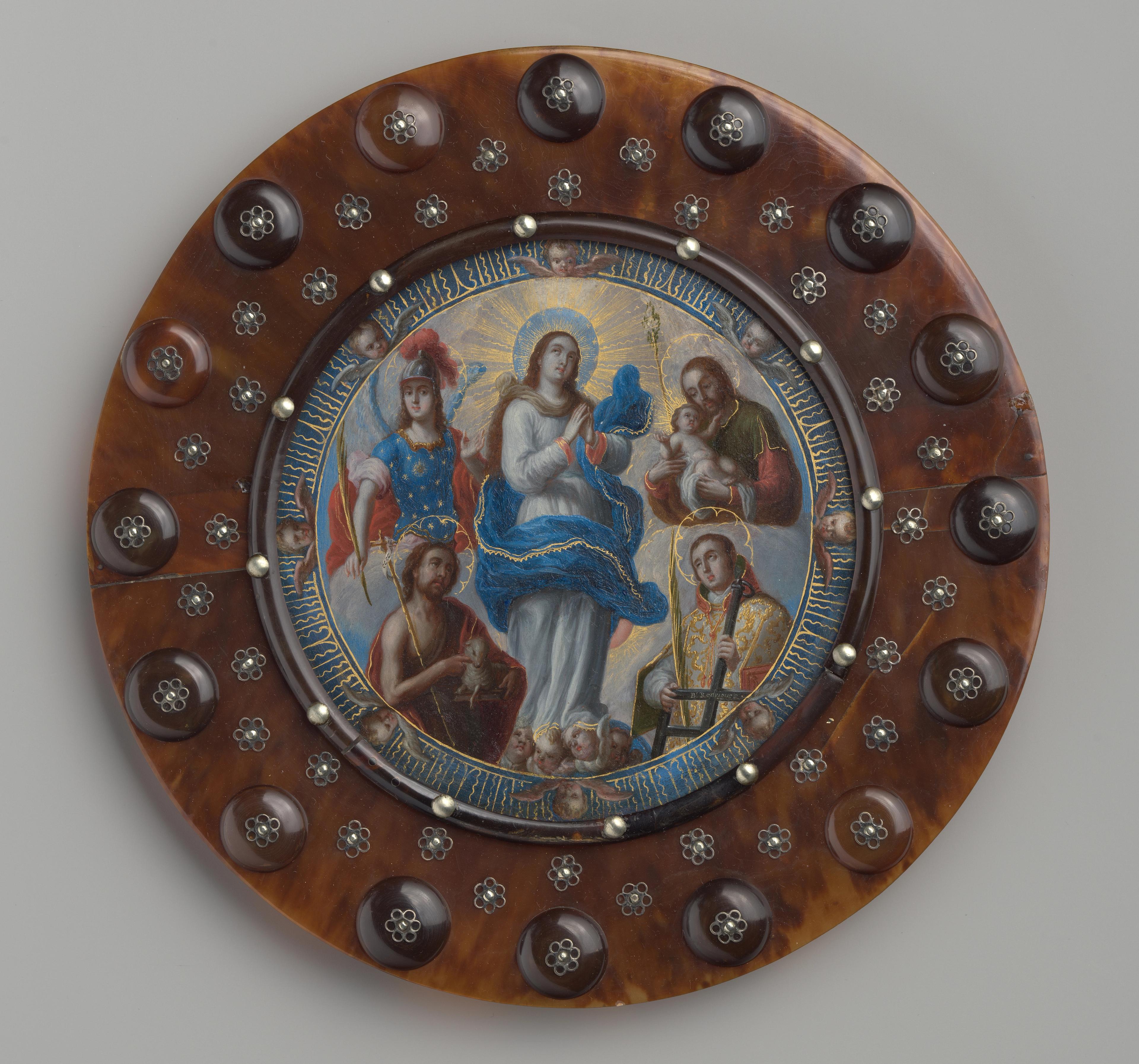 Pictorial medallion. The central image shows the Virgin cast in ethereal light, surrounded by five figures. The tortoiseshell frame is decorated with small silver flowers.