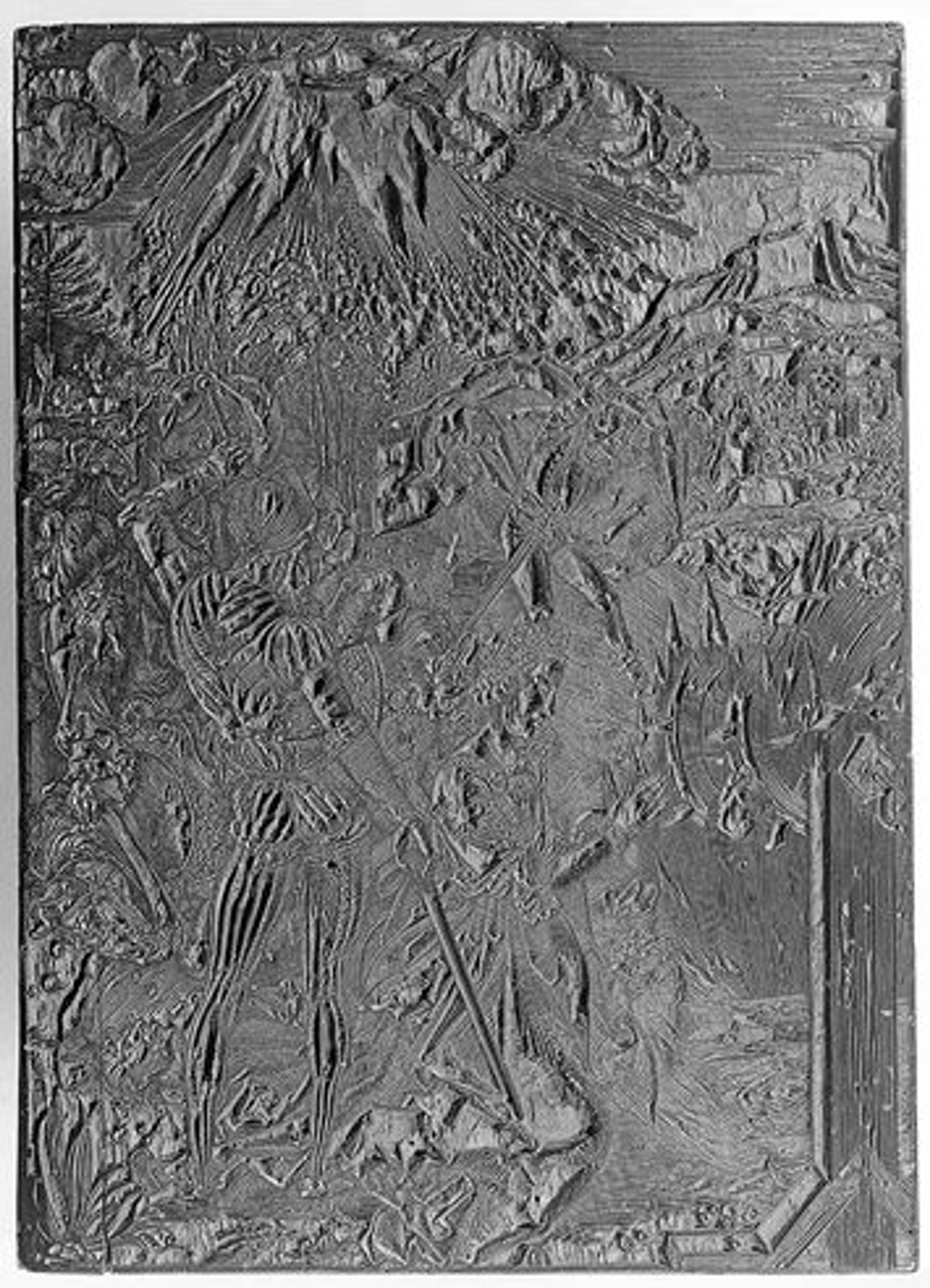 Surface of a dark wood block textured with the engraved lines used to create the woodblock print