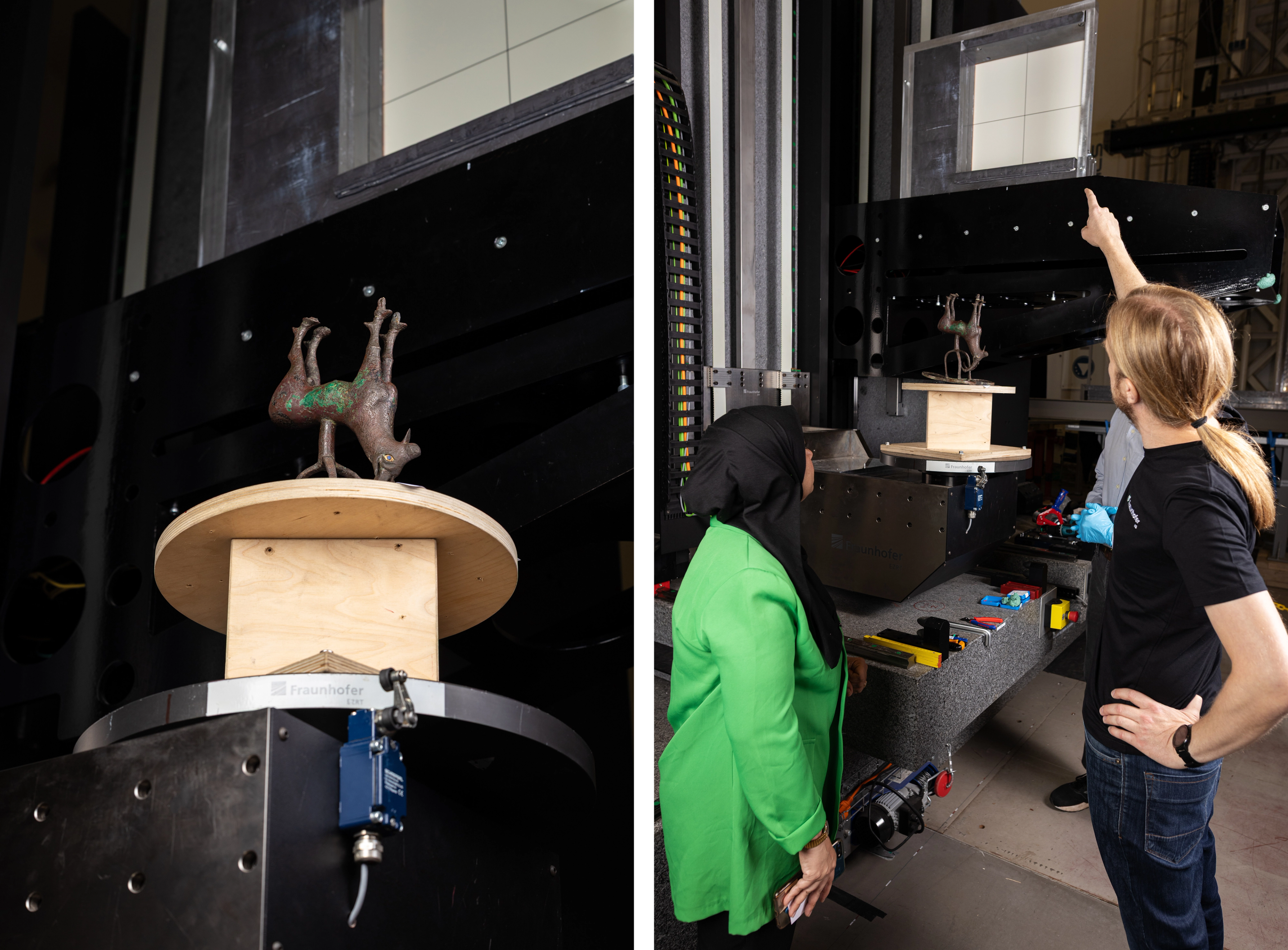on the left an ibex sculpture on a circular stand. on the right a man with long blond hair pointing at a machine and a woman in a green top and black headscarf looking