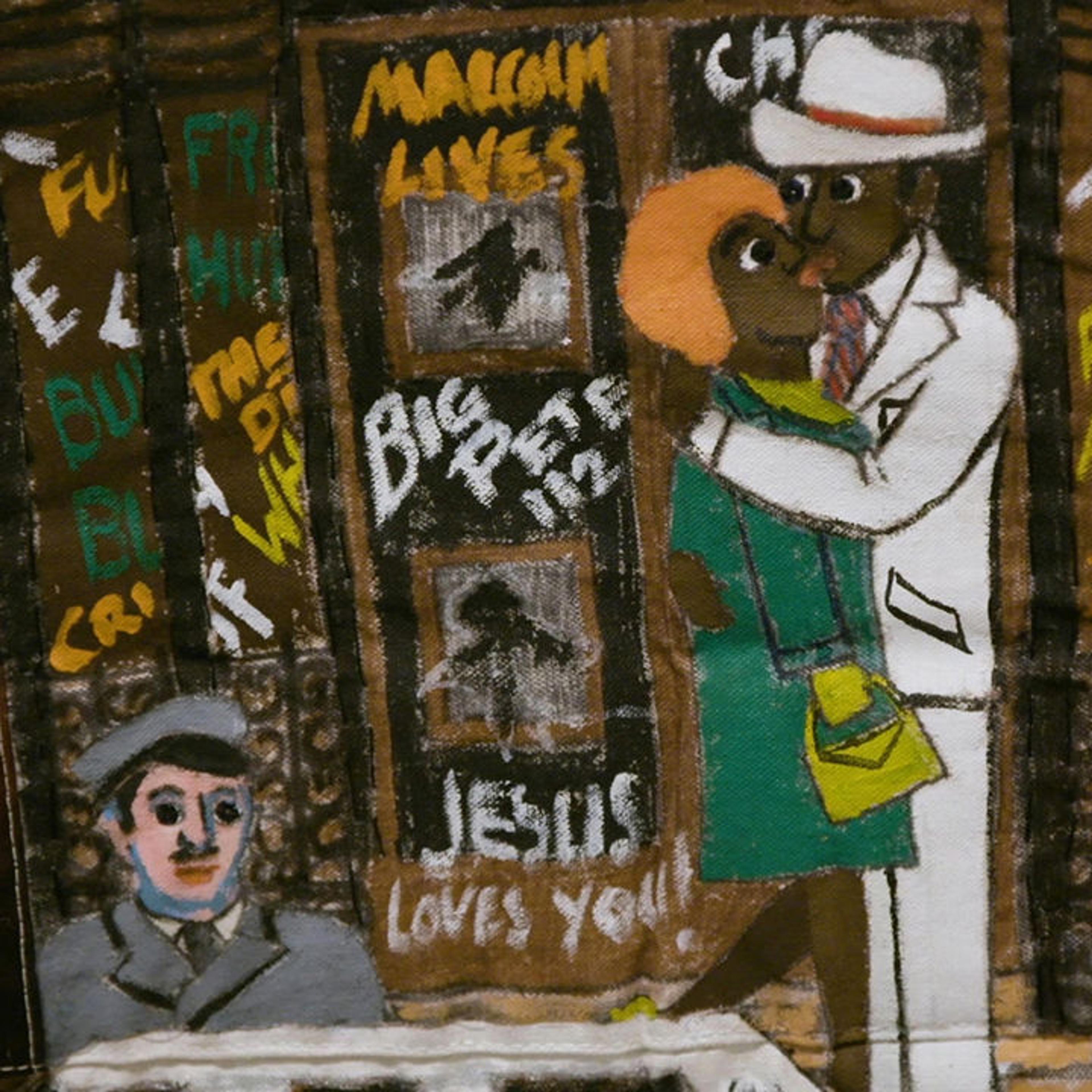 A close-up image of Faith Ringold's Street Story Quilt. In this segment you see a black man in a white suit and hat embracing a black woman in a green jacket, with a purse, and orange hair. Behind them there is a building covered in graffiti, with shattered windows on the door they are standing in front of. In the lower left, there is a limousine driver in a grey suit.