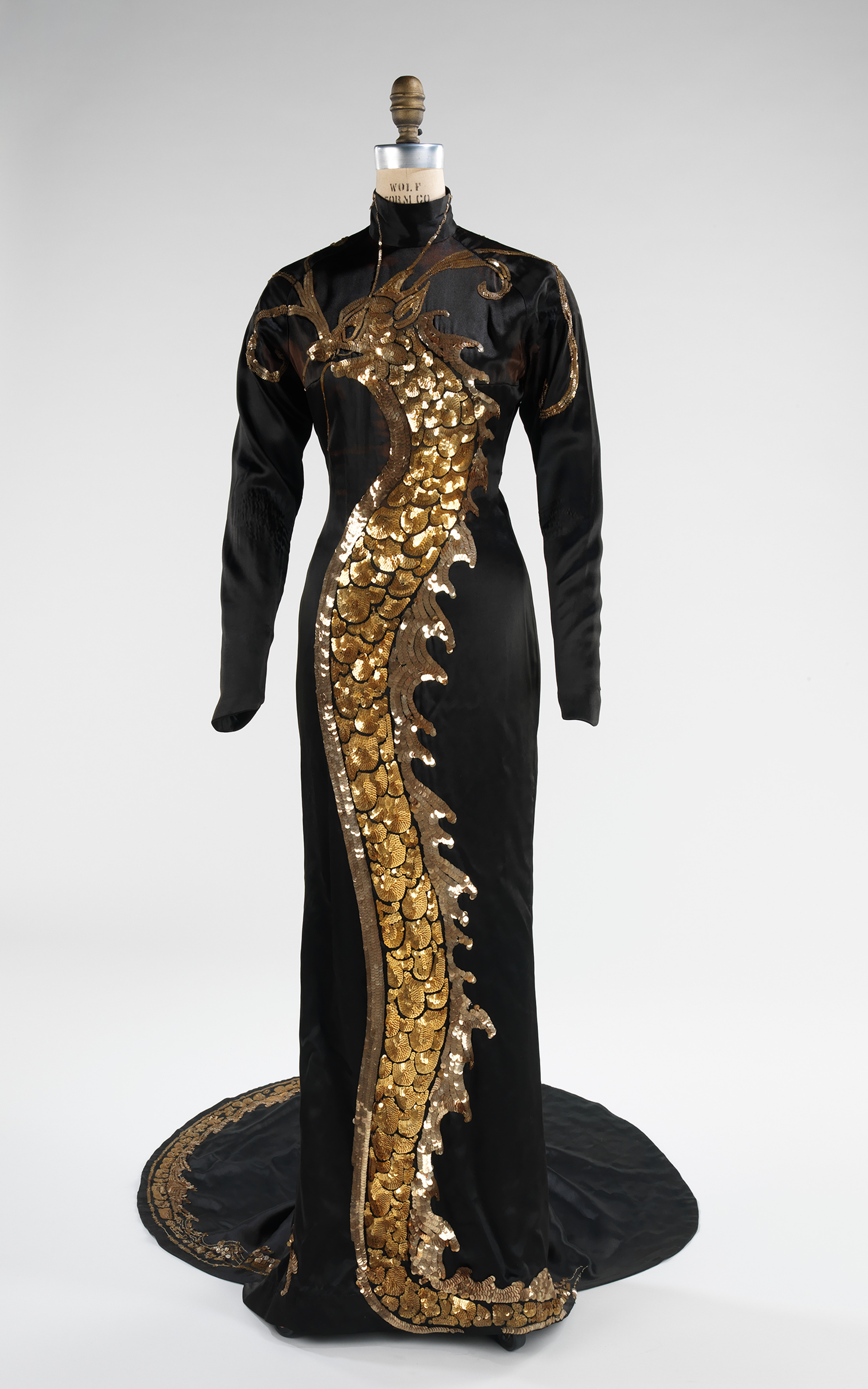 Image of long black dress, with gold dragon depicted.