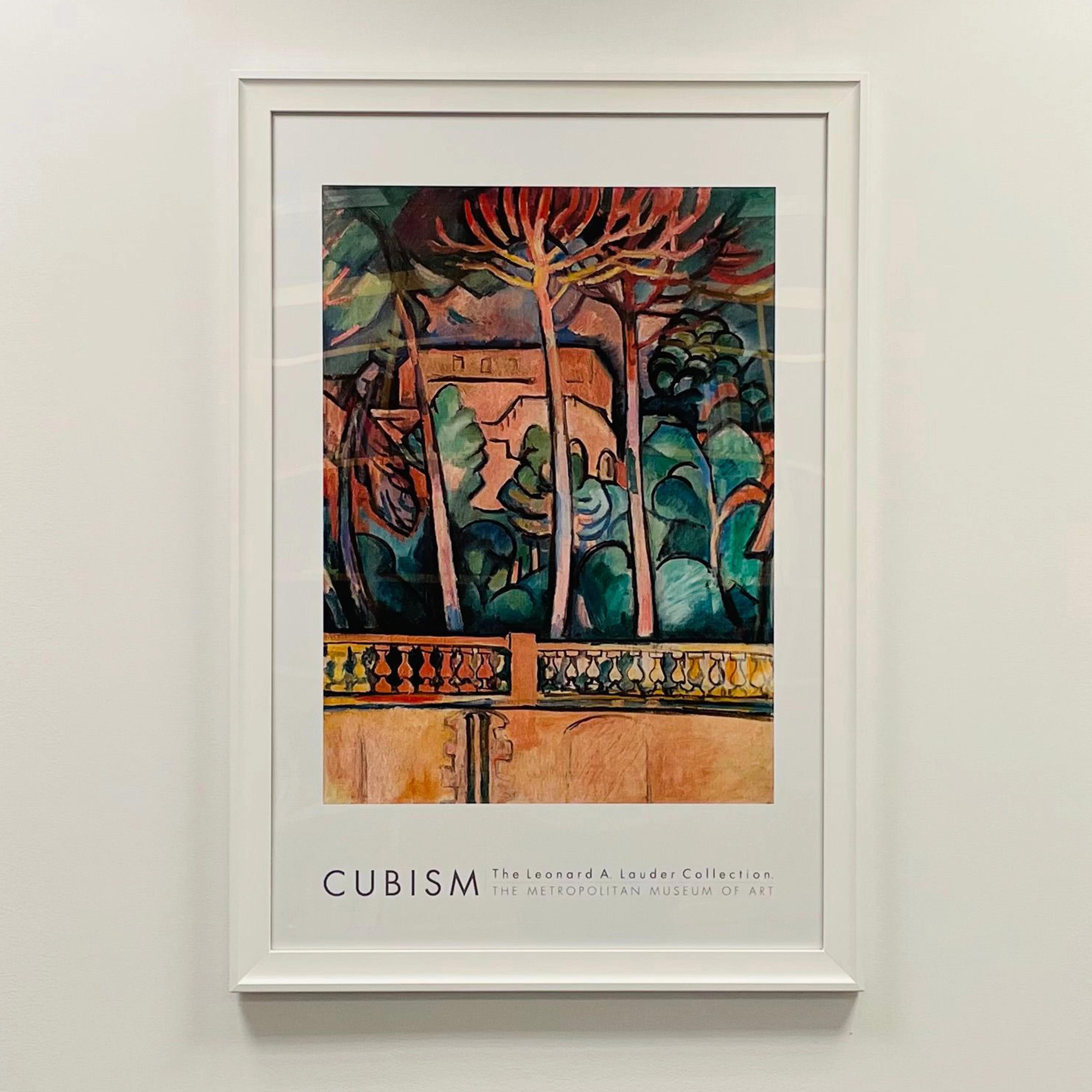 Framed Cubism poster displayed on a white wall. Poster features abstract artwork with various shapes and colors, with the label "CUBISM" at the bottom of the frame.
