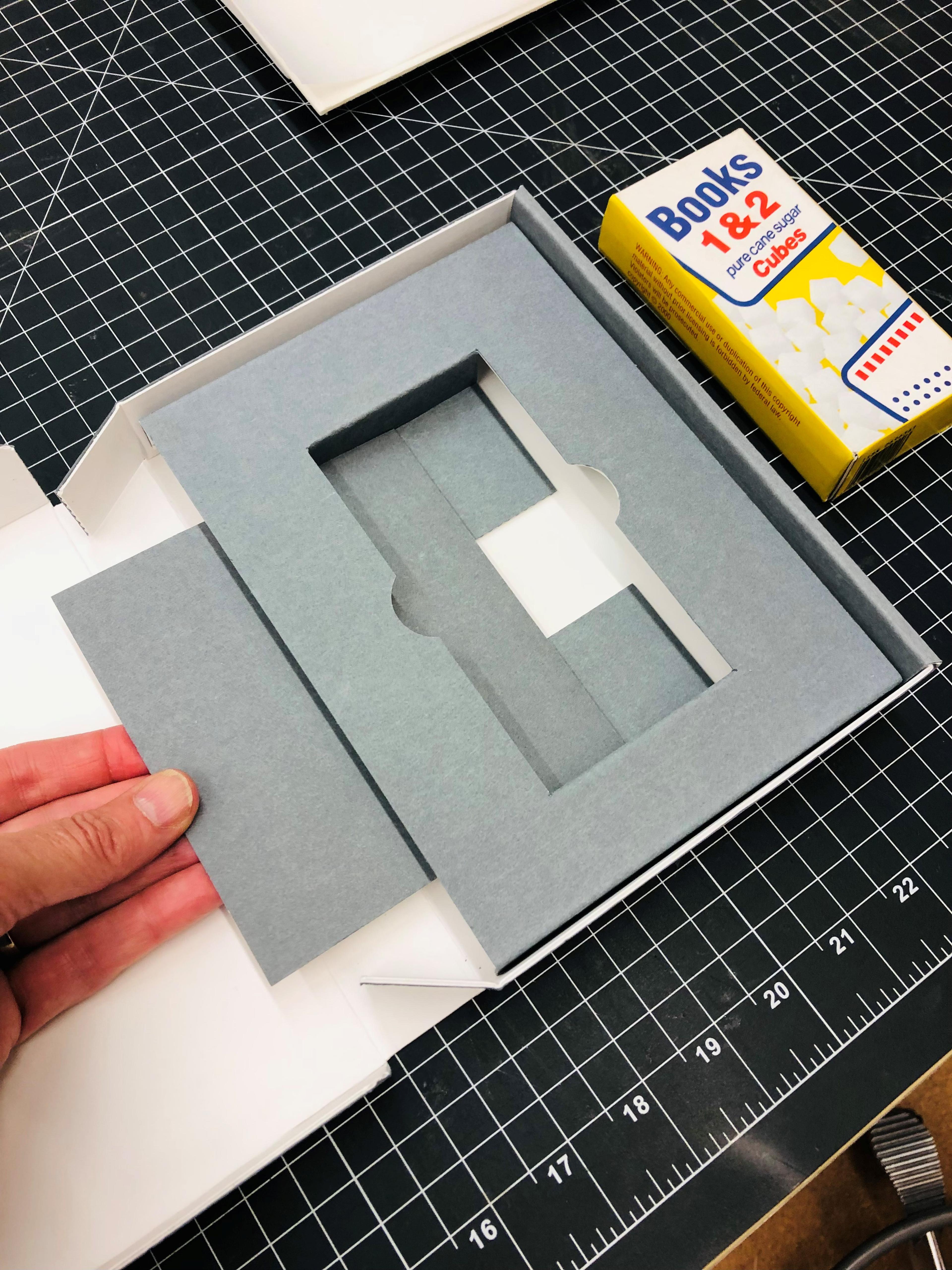 Hand pulling the insert of a library box.