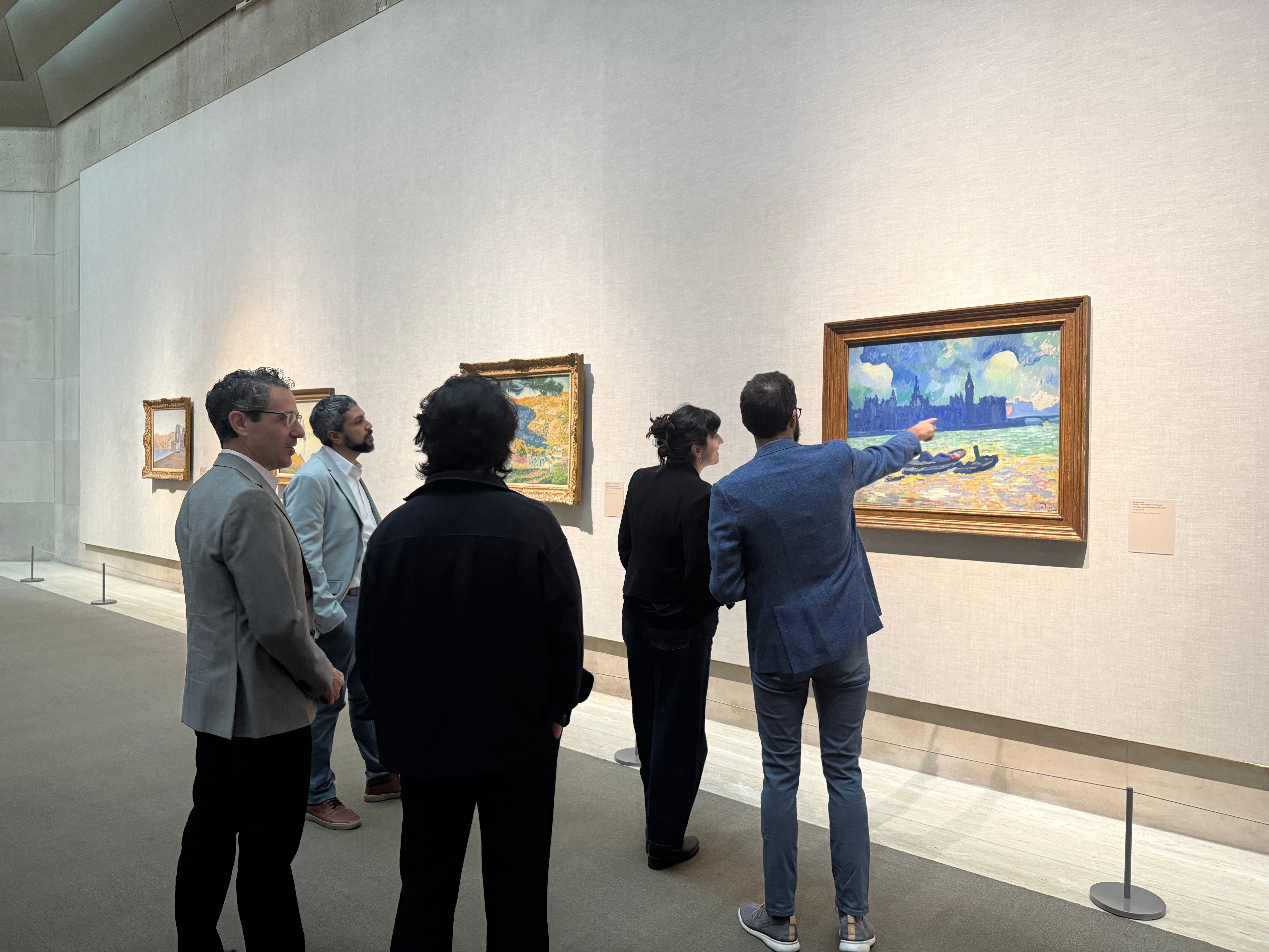 A collection of adults standing in the Lehman galleries. 