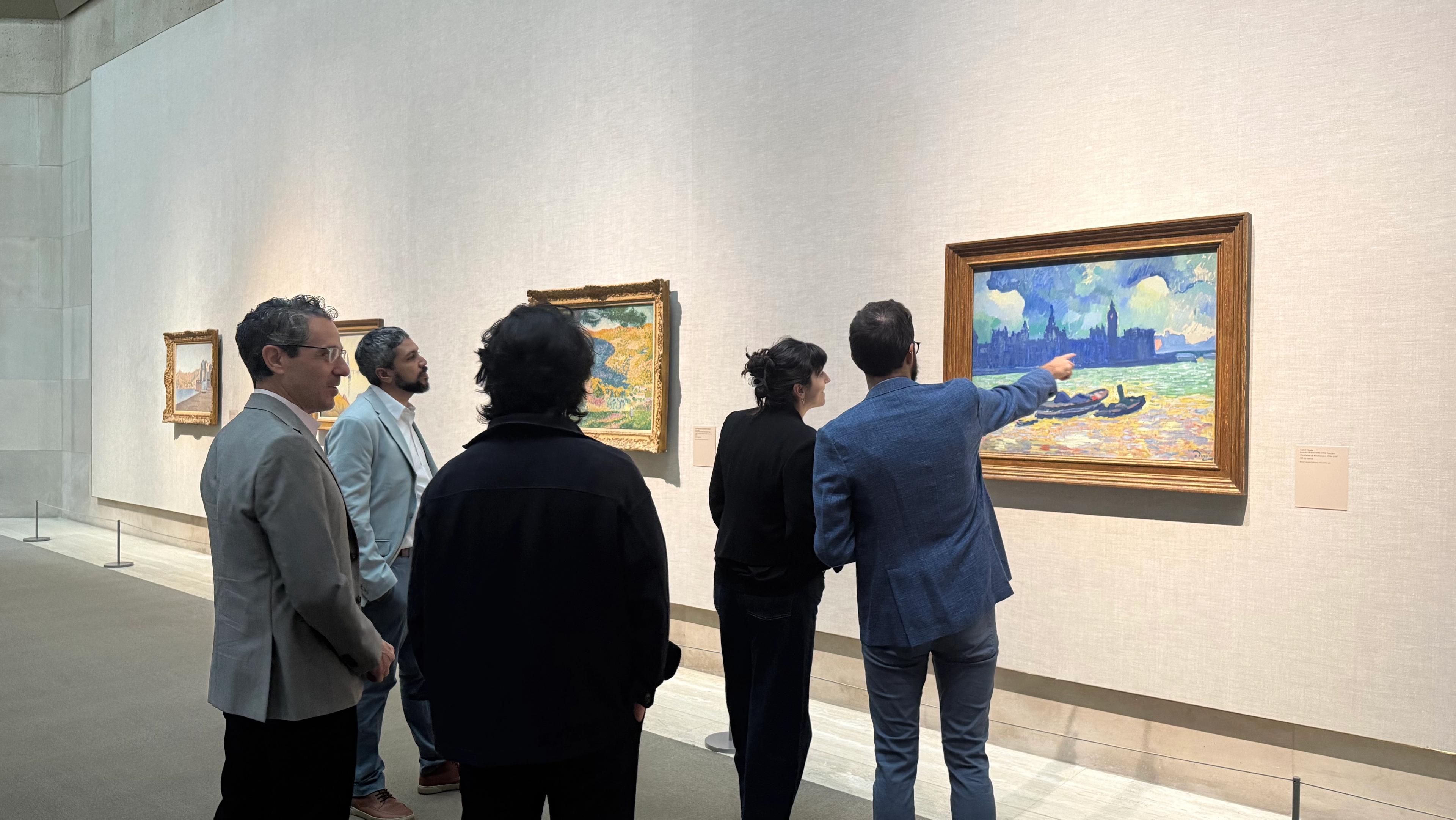 A collection of adults standing in the Lehman galleries.