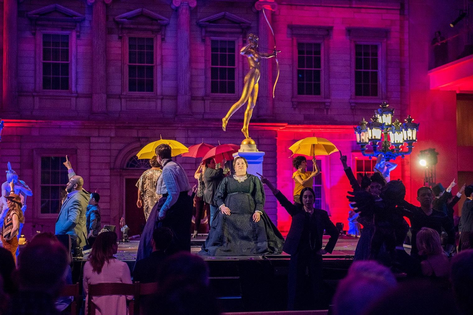 An opera is performed in the American Wing court
