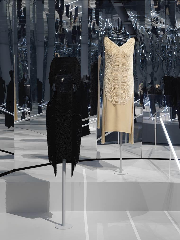 Installation view of the previous dress mount being used for a black, string dress next to a white string dress of a similar style