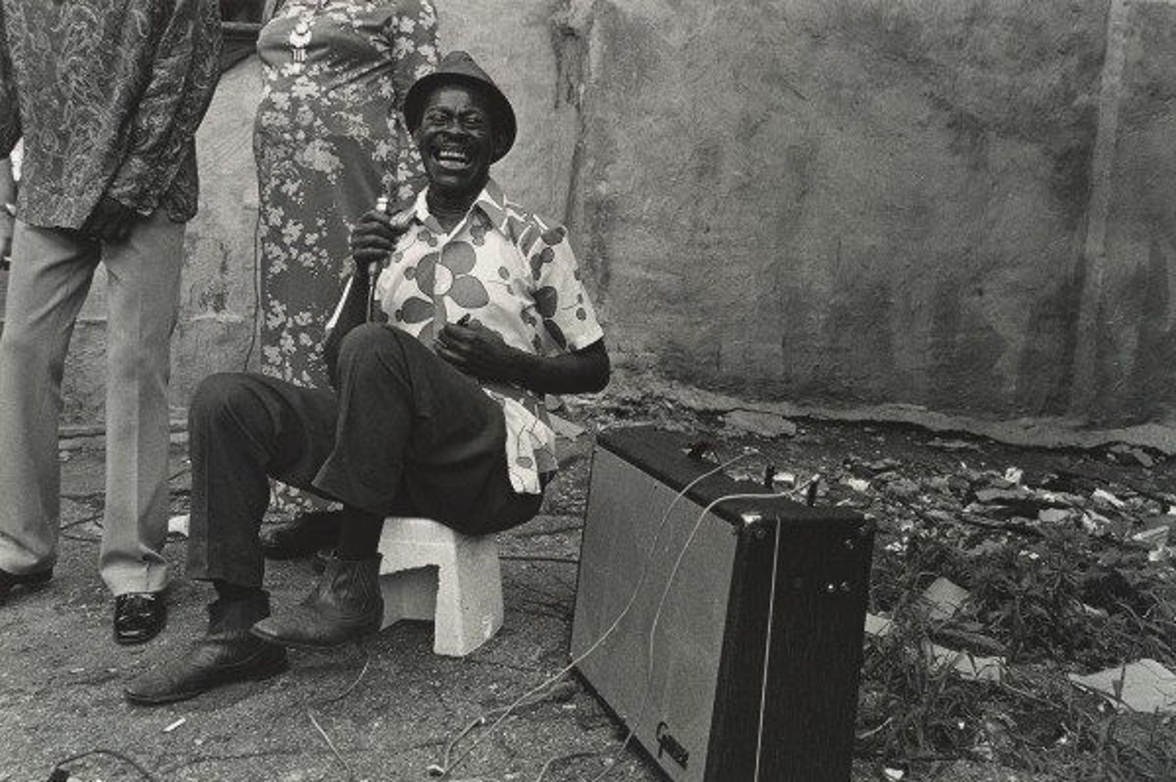 Black and white photograph of a blues singer on the street