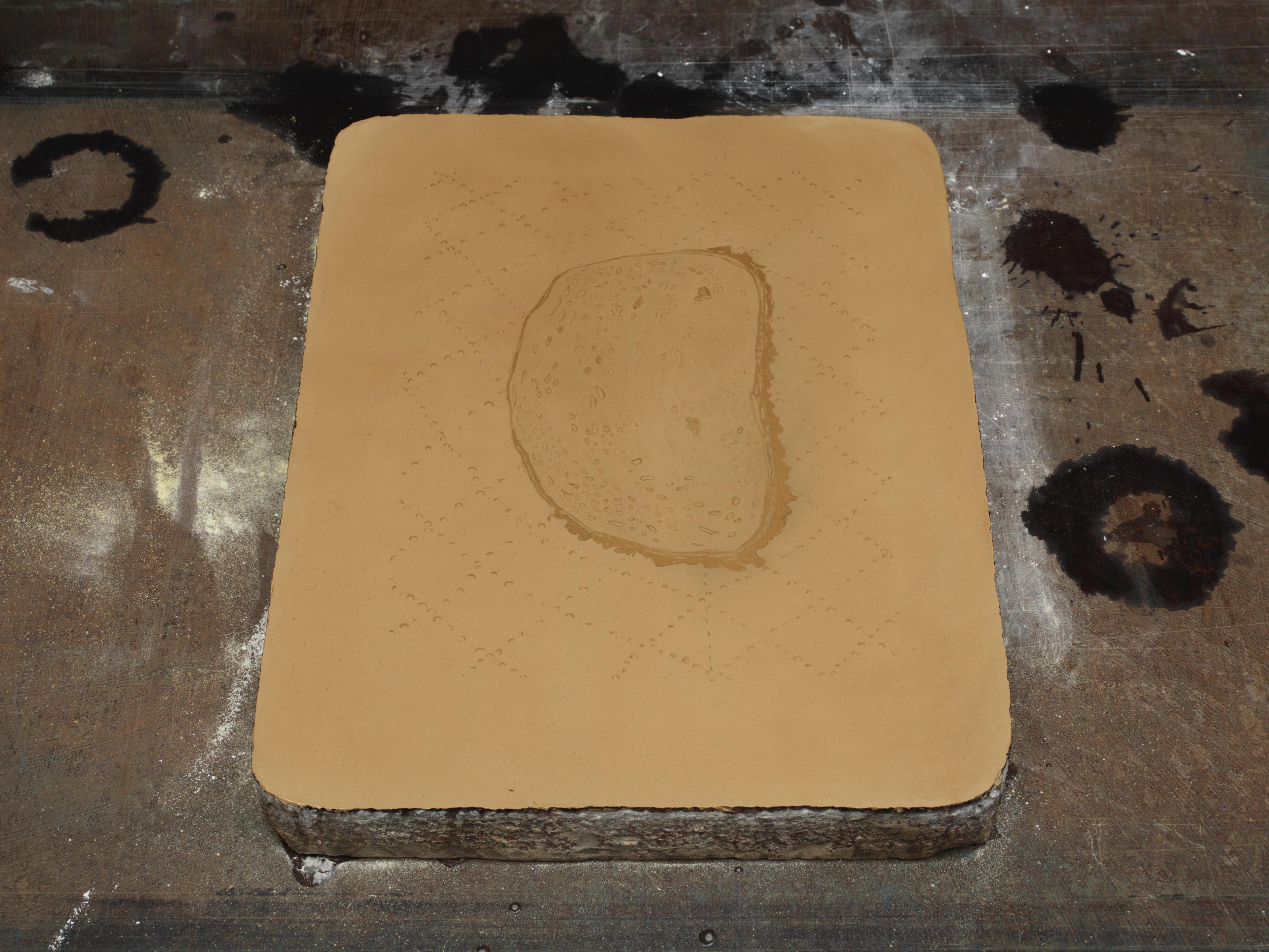 Photo of a lithography stone with asphaltum.