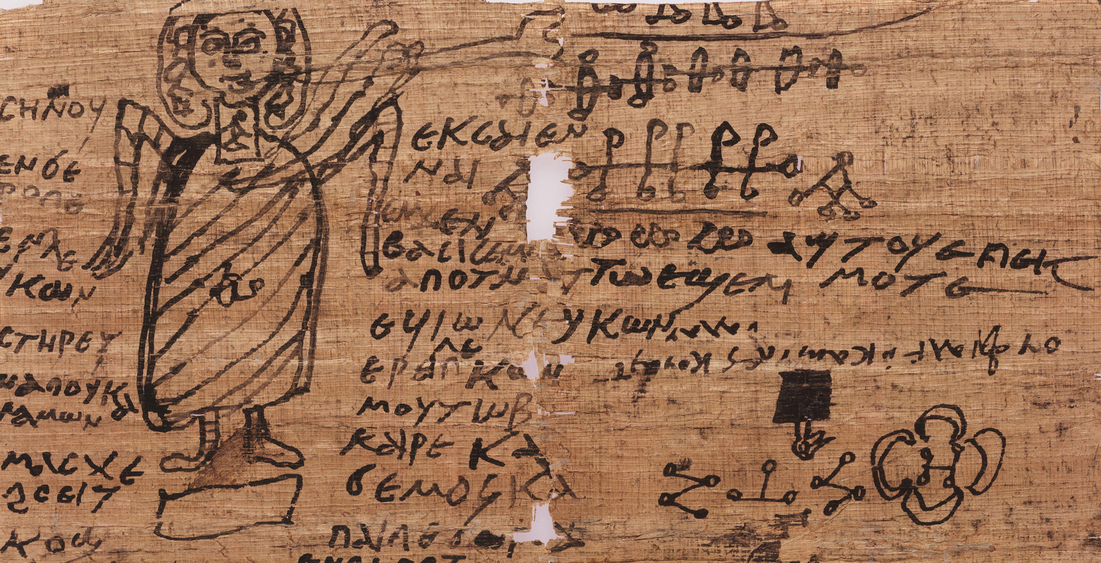 A papyrus with a hand-drawn winged figure, Greek text, and abstract symbols, showing signs of aging and wear.